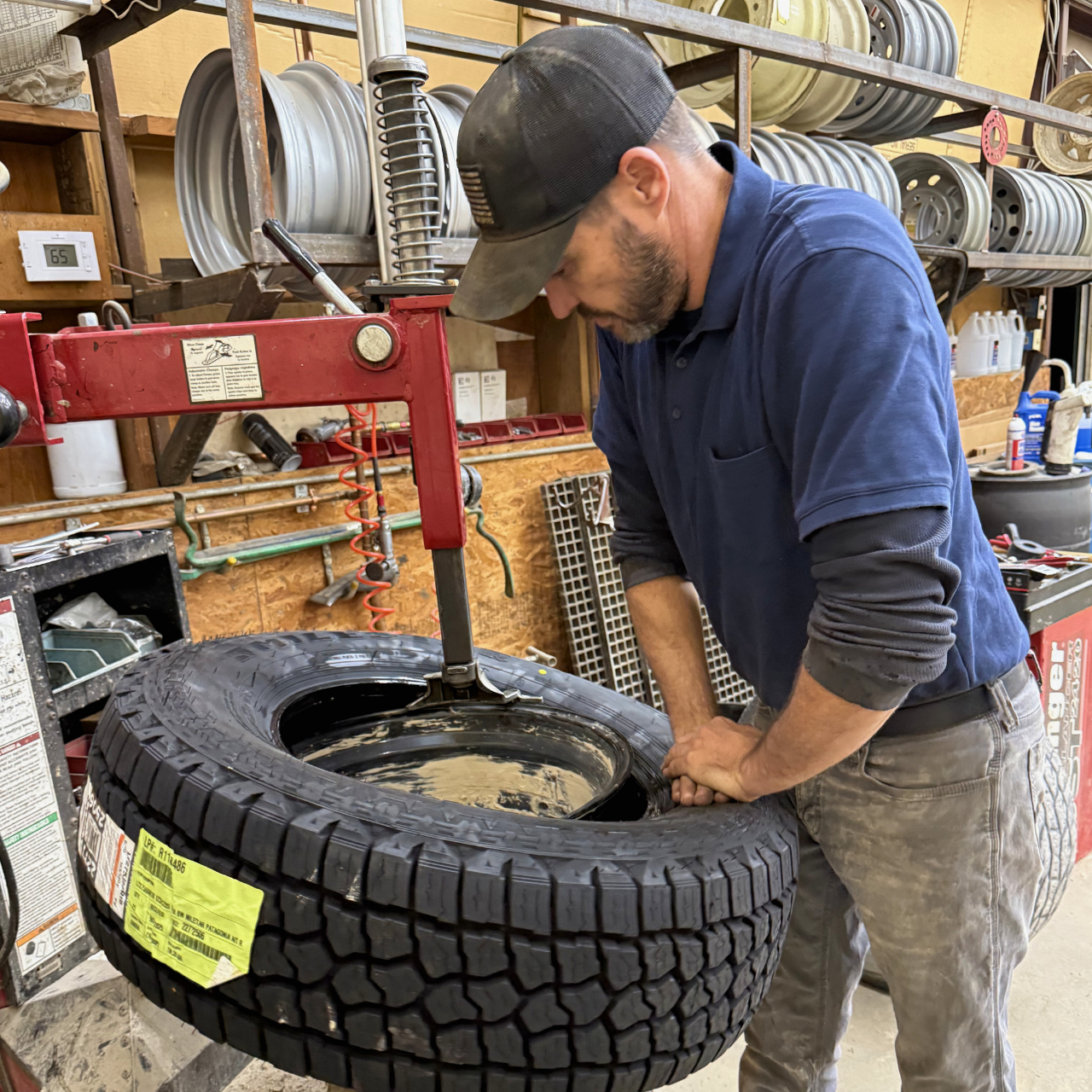 Stanley Heckman, owner of CSH Trailers & Automotive Services, located in Westphalia, MO, works on a tire install