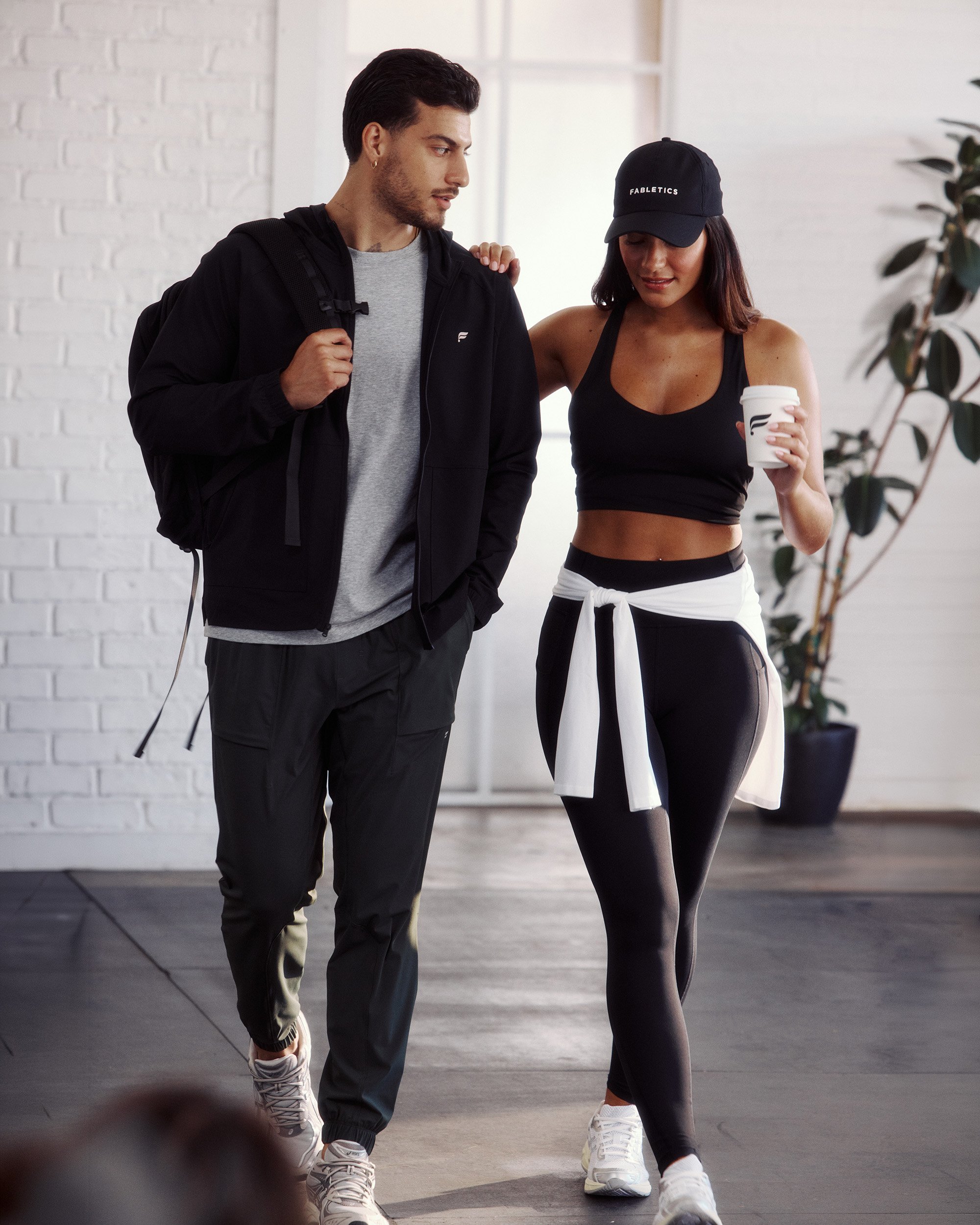 Art director on-figure e-commerce shoot, Los Angeles. A man walking out of a gym with a woman.