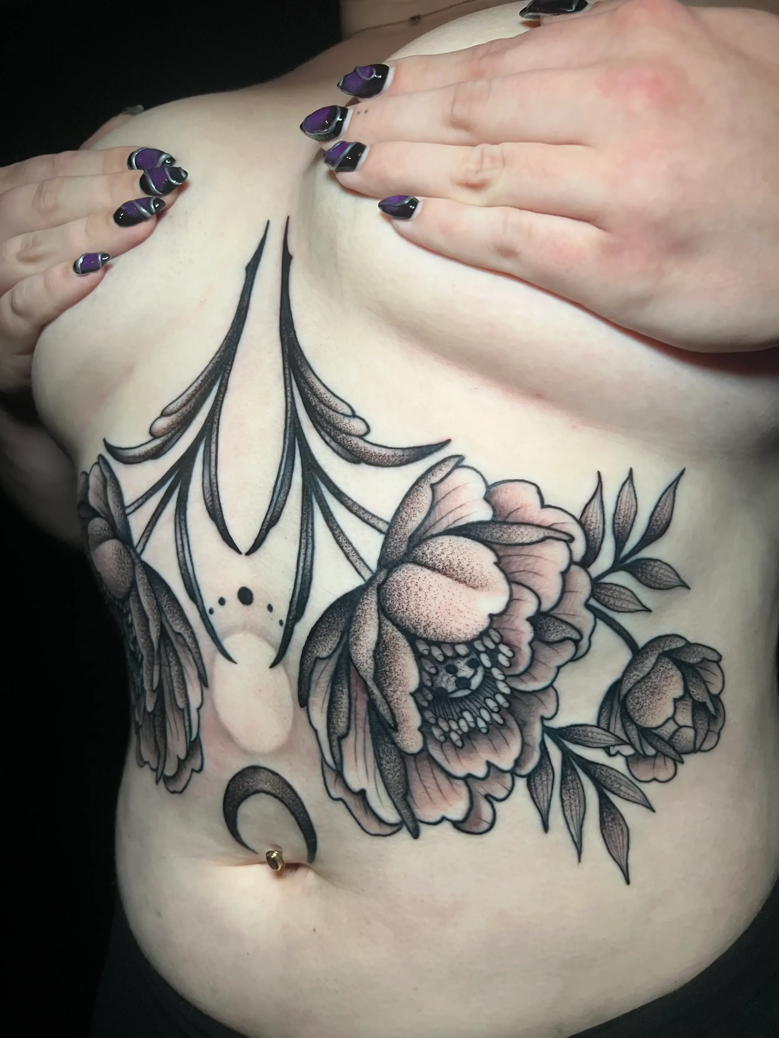 Blackwork sternum tattoo with peony flowers and leaves.  Done by female tattoo artist Dana Carlson in Virginia Beach.