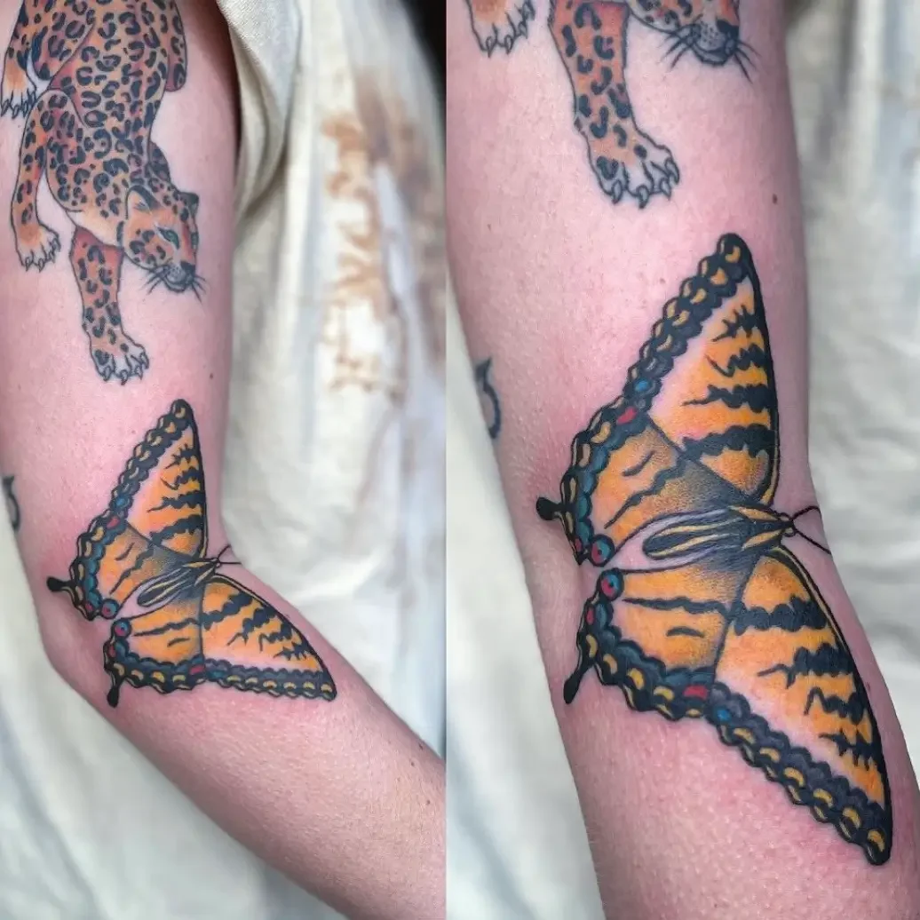 Tattoo of a monarch butterfly on a person's elbow in an American traditional style. Custom design by Jess, tattoo artist in Richmond, Virginia.