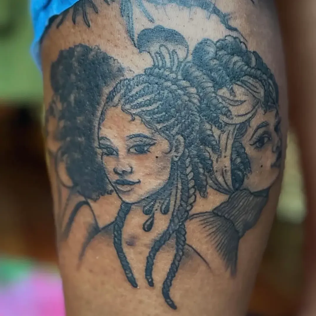 Black and gray tattoo of three women with styled hair on a person's arm. Custom design by Jess, tattoo artist in Richmond, Virginia.