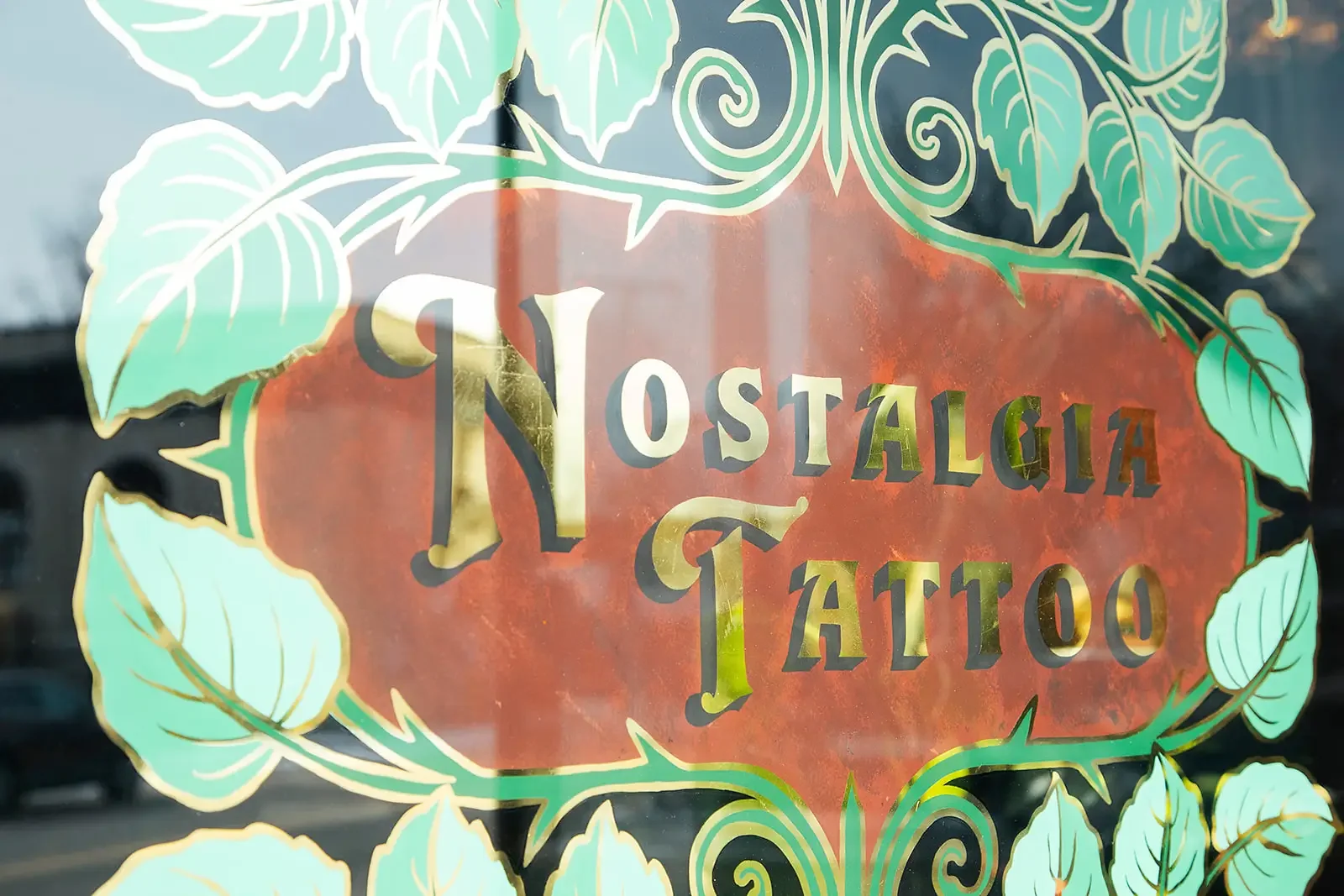 Nostalgia Tattoo logo on window of studio in  Richmond, VA.