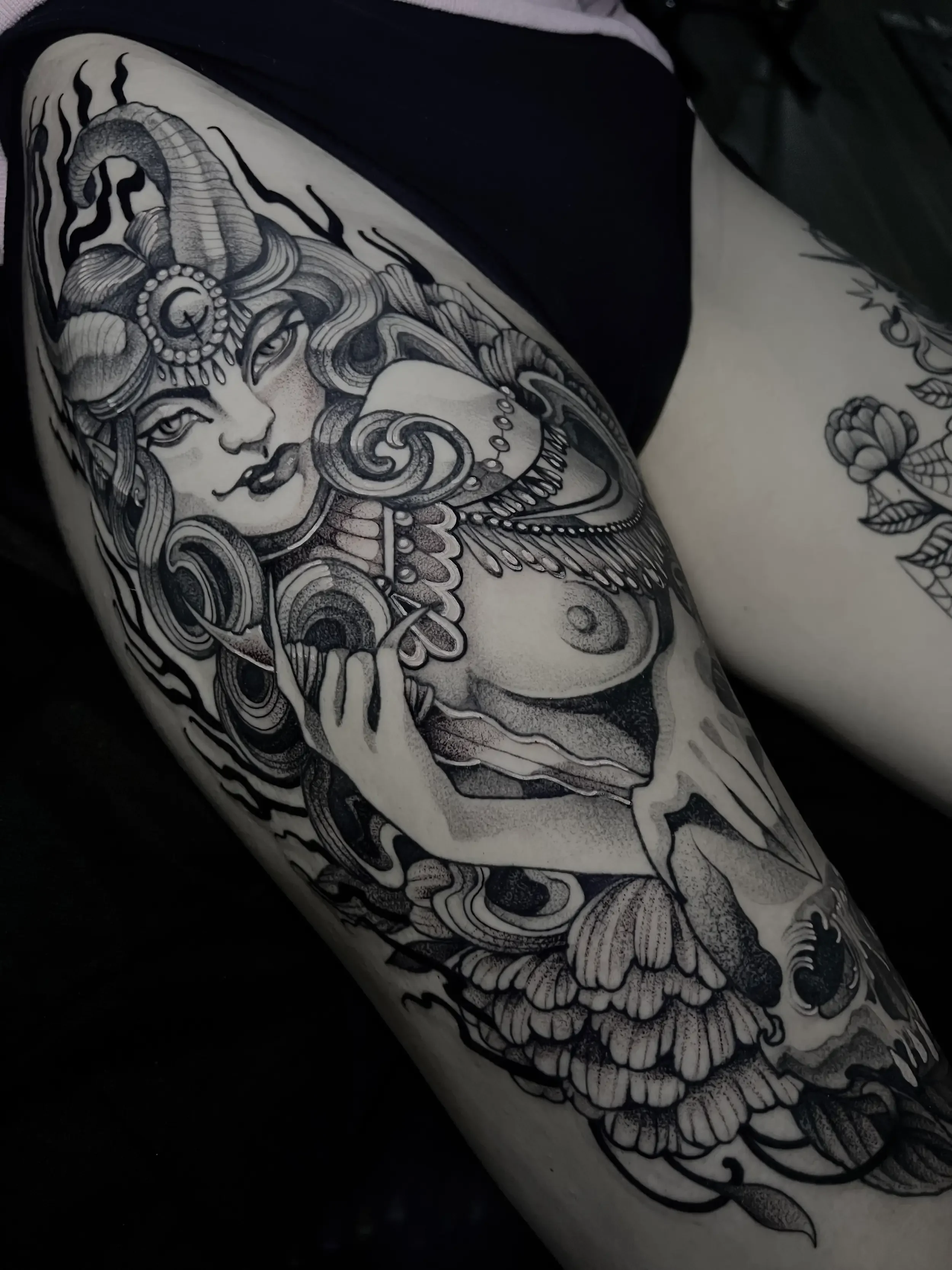Black and gray neo-traditional tattoo of a mythological female figure with horns and elaborate jewelry on a person's arm. Done by female tattoo artist Dana Carlson in Virginia.