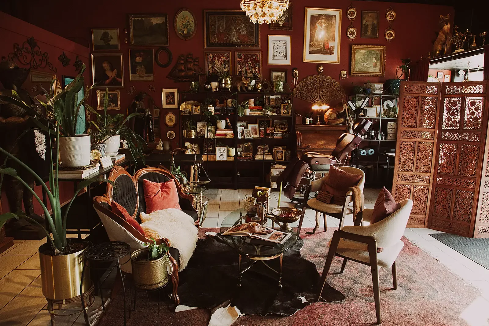 Maximalist tattoo studio consultation and waiting area with plants, art, and vintage decor in Richmond VA.