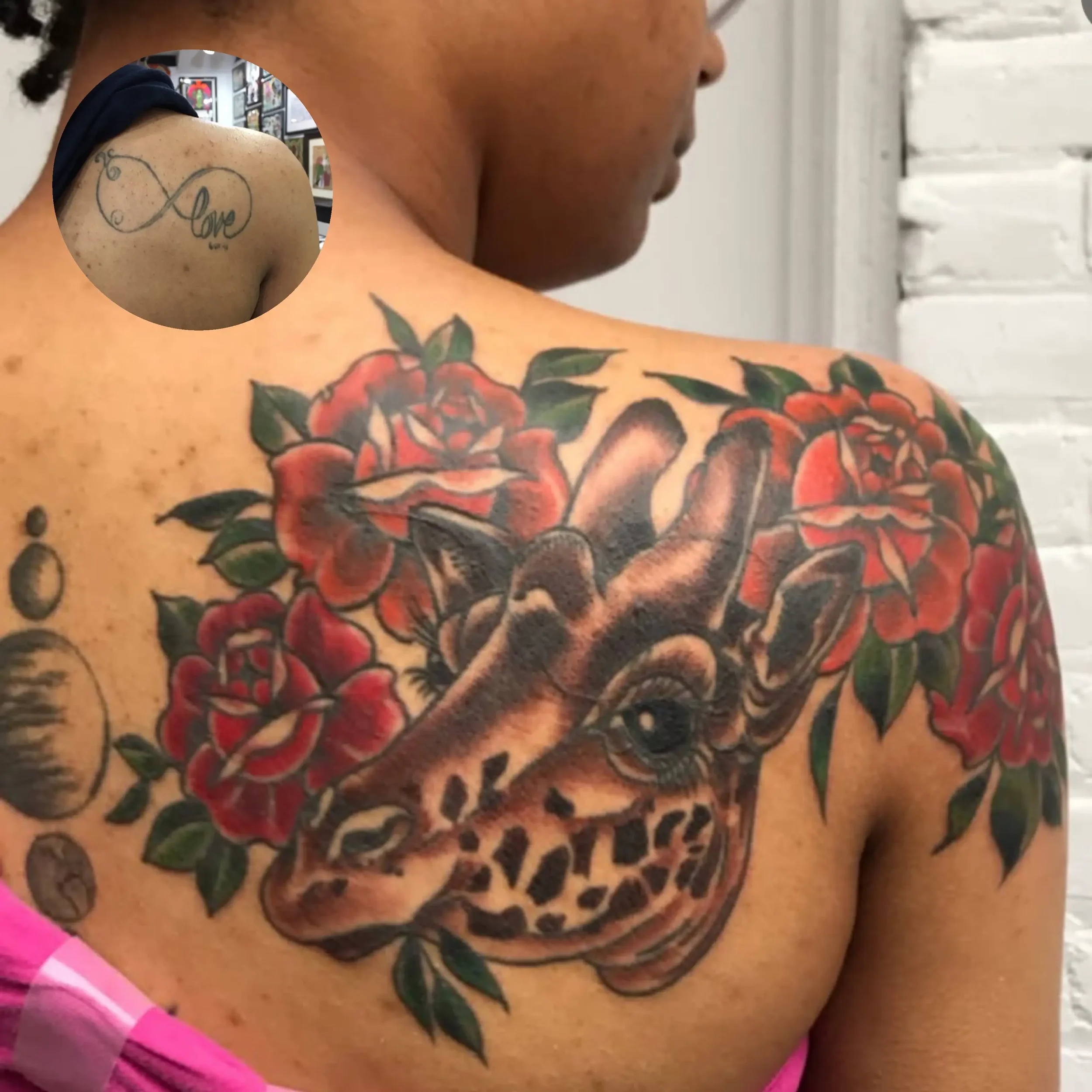 Coverup tattoo of a giraffe's head surrounded by roses on shoulder. Custom design by Jess, tattoo artist in Richmond, Virginia.