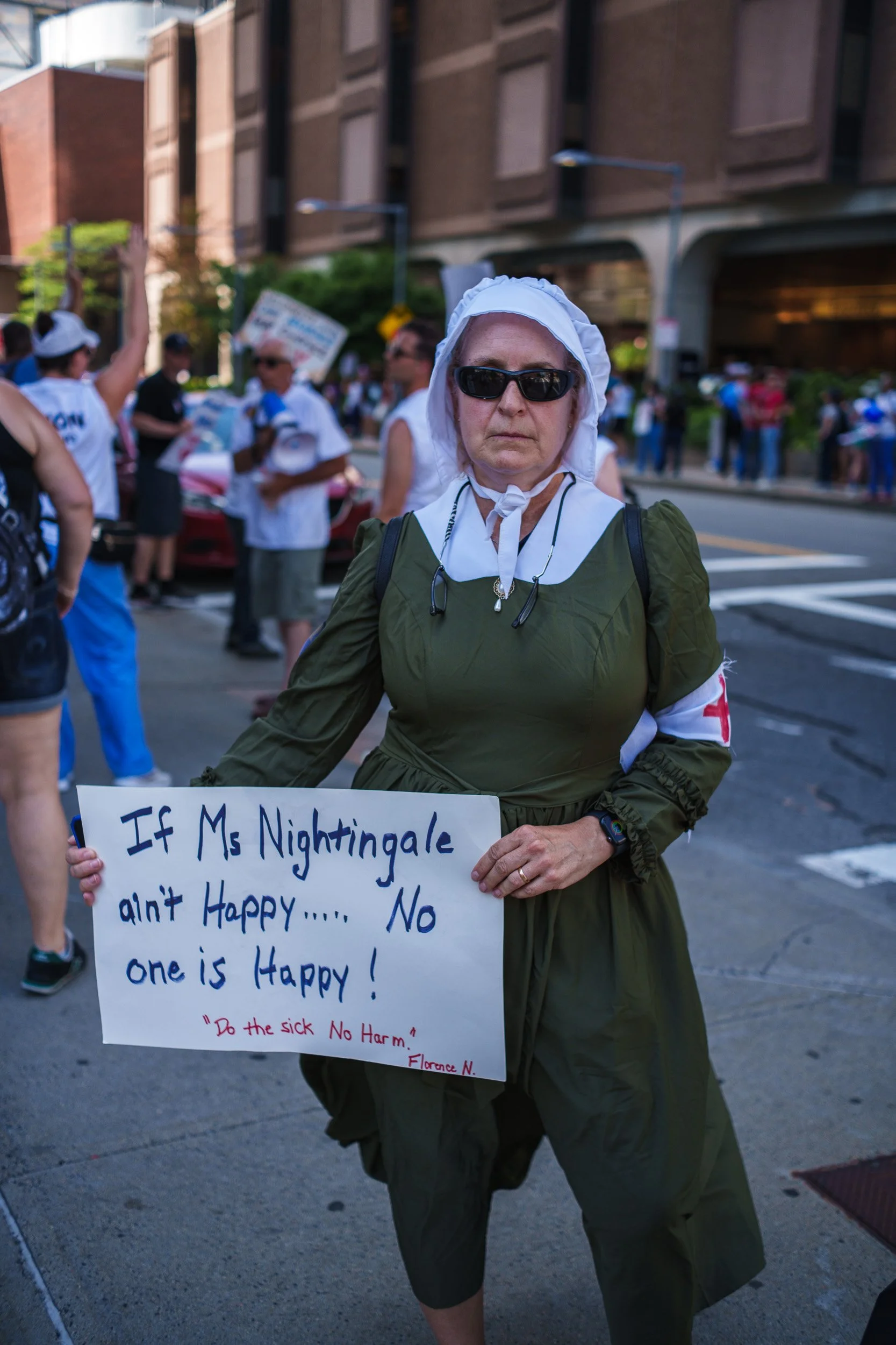 A protester stops to pose for a portrait while dressed as Florence Nightingale during the July 9, 2026 Mass General Brigham Nurse protest In Boston, MA.  Florence Nightingale (1820-1910) is remembered as the founder of modern nursing and credited for