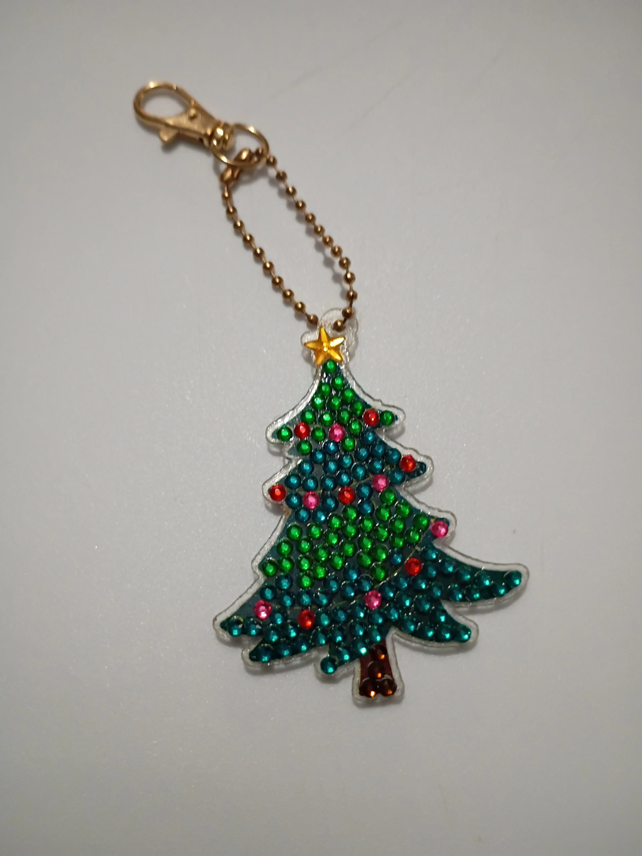 blue and green Christmas tree key chain