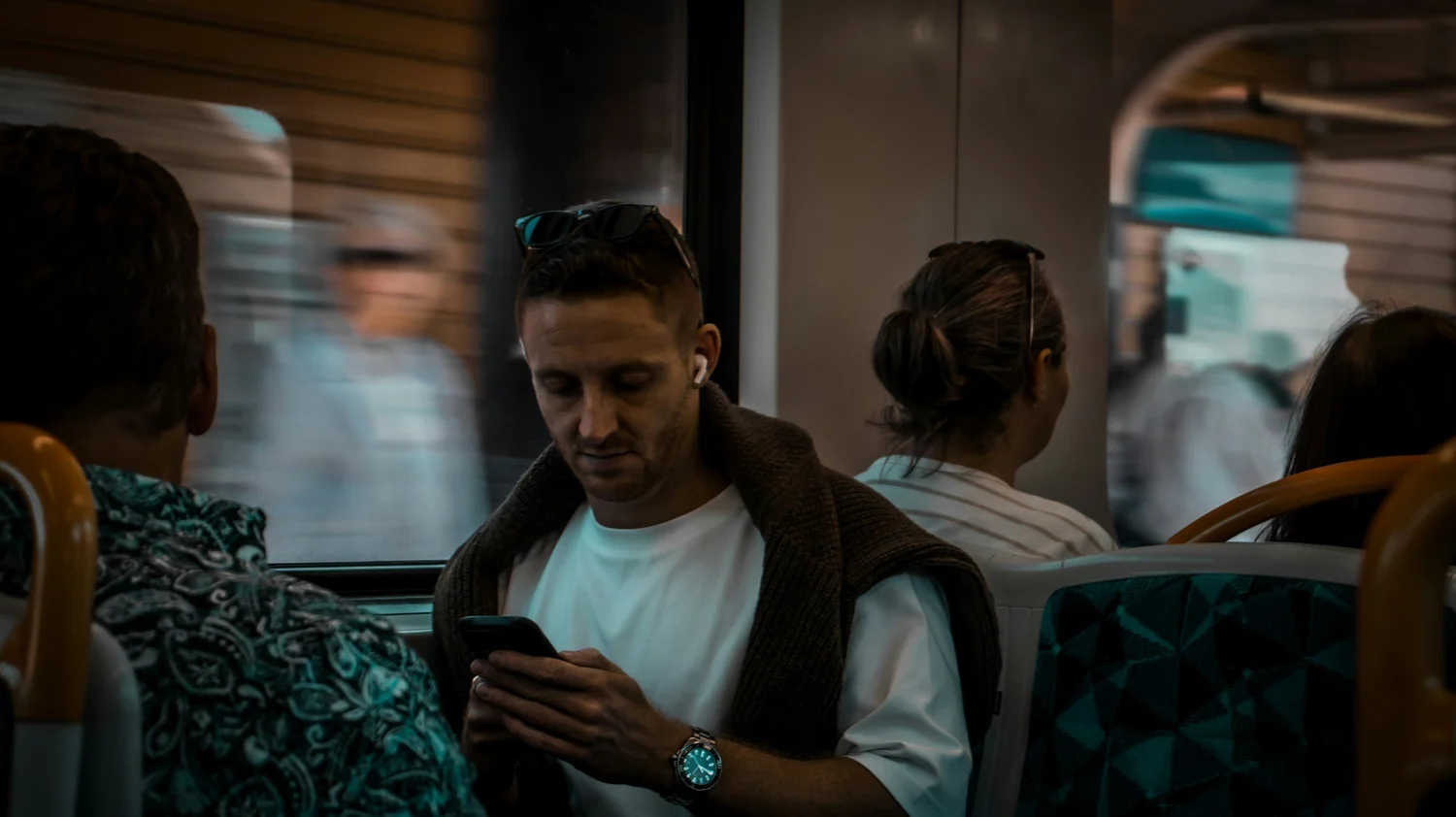 Commuter reading a message on a phone