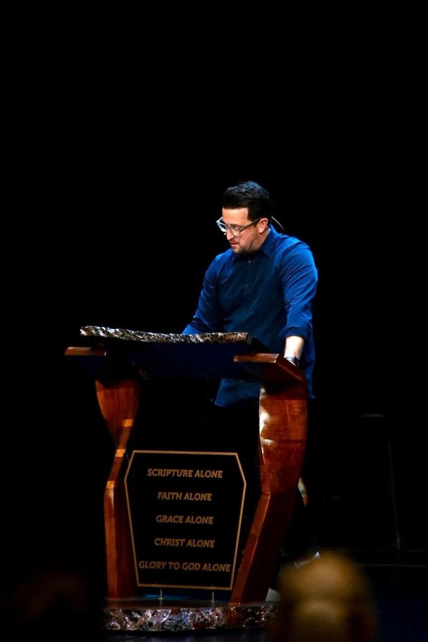 Pastor Logan preaching at church