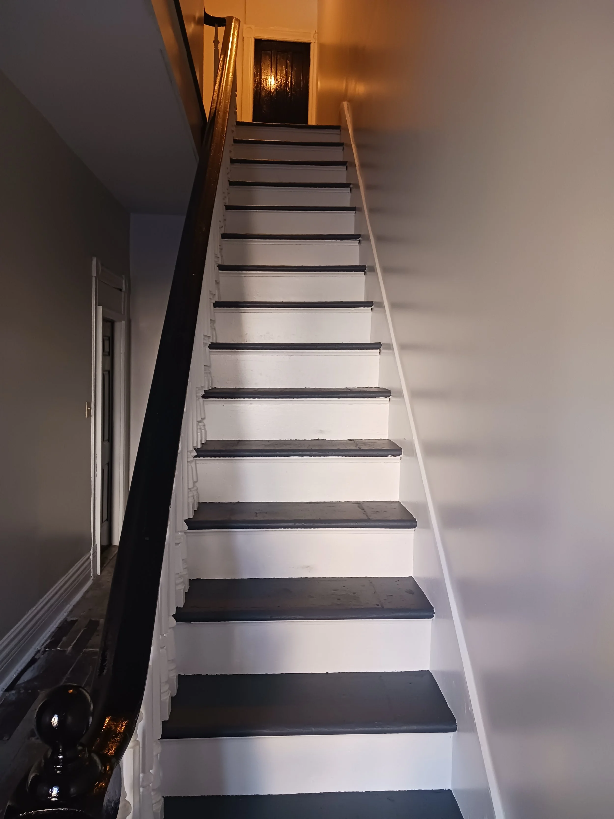 After a thorough cleaning everything was sanded for the paint to adhere properly and provide a smooth finish. walls/trim/ceiling areas were all finish coated with 2 coats and the stair treads were finish with flooring enamel paint to withstand the fo