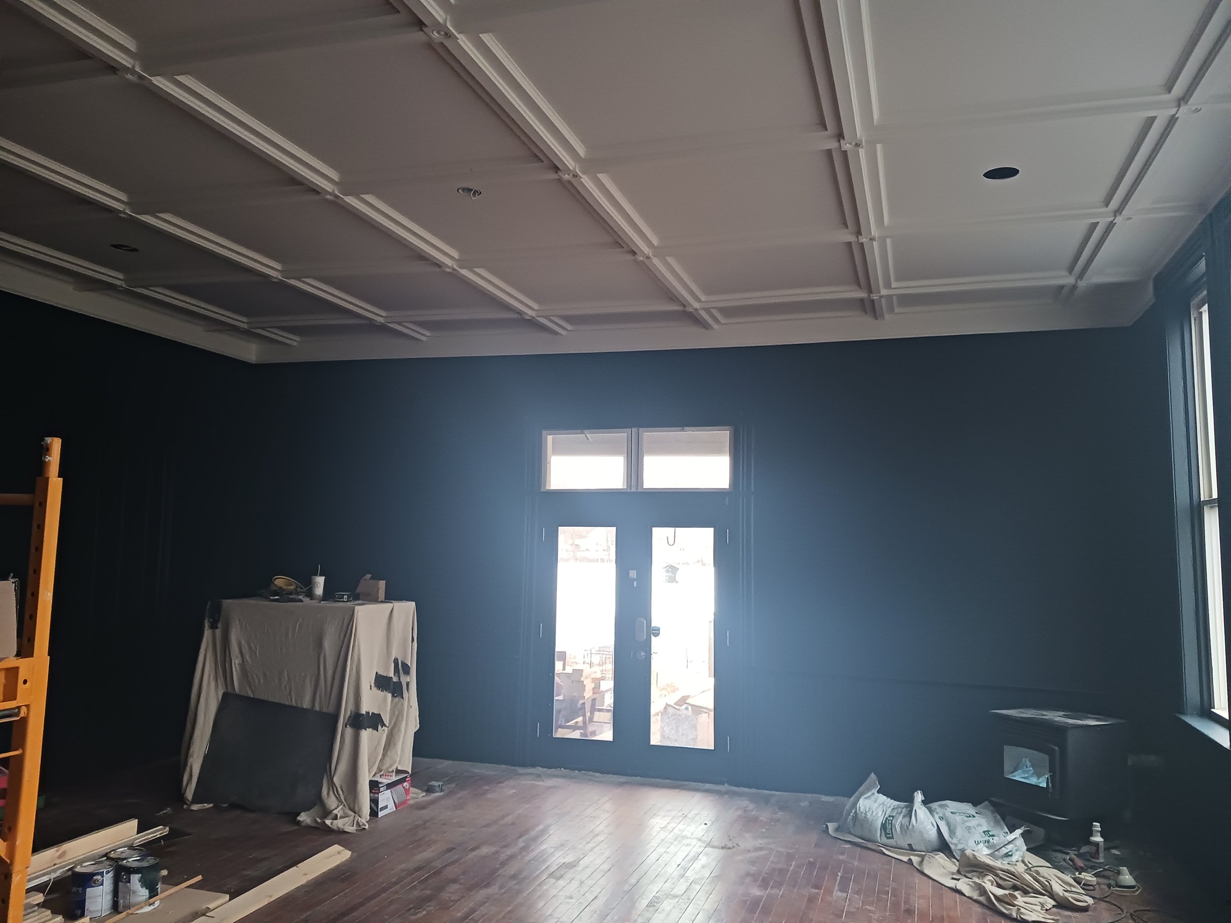 After thoroughly prepping all the detail in the ceiling we were able to spray primer/finish and 2 coat the walls and remaining trim in this room that will later be used for wedding and other venues in the future.