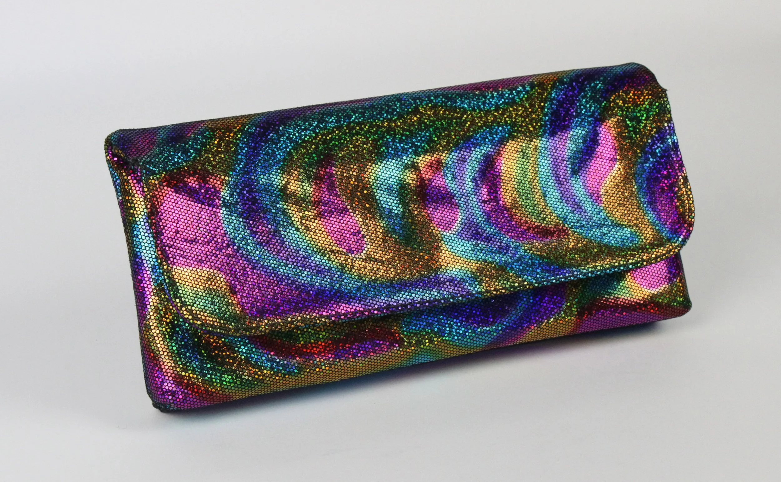 A colorful, shiny clutch purse with a swirling, multicolored pattern and a reflective surface.