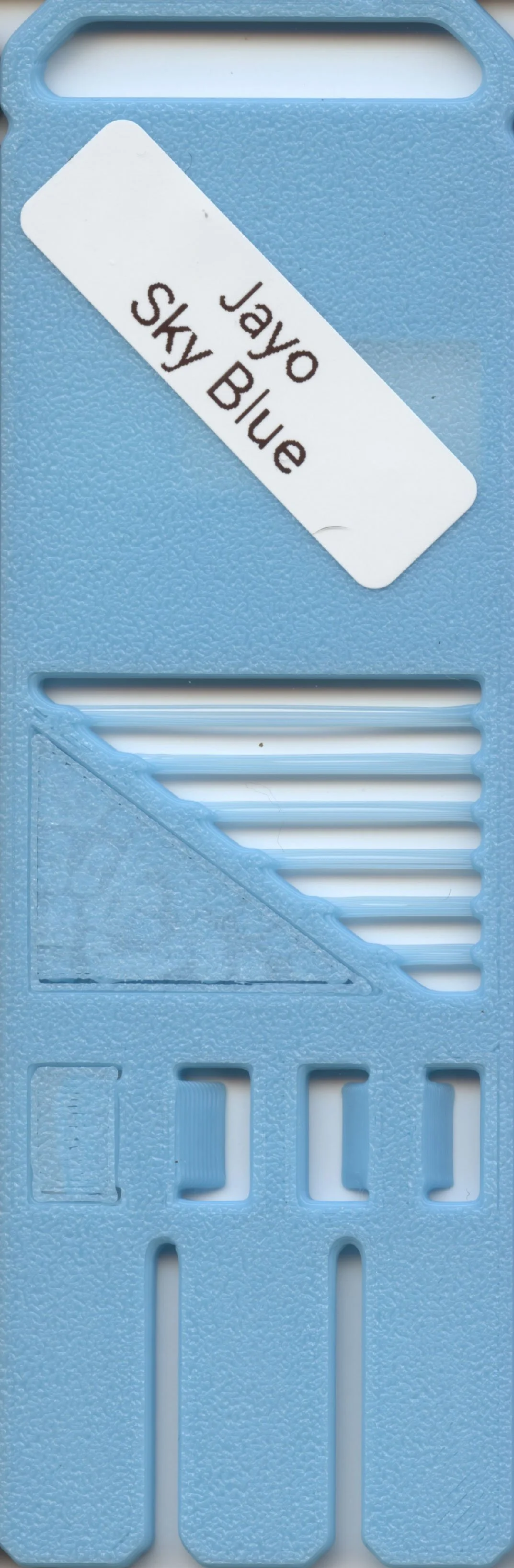 A light blue plastic ruler with a white label that reads "Jayo Sky Blue".