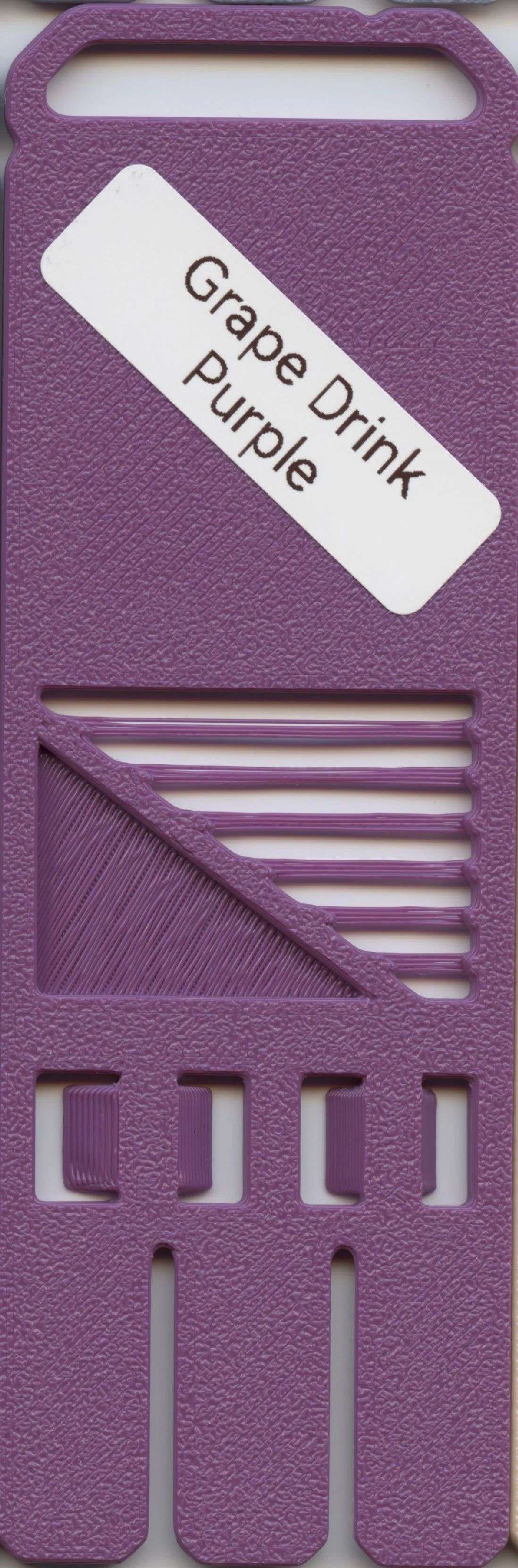 A textured purple plastic snack bag holder with a white label that reads "Grape Drink Purple."