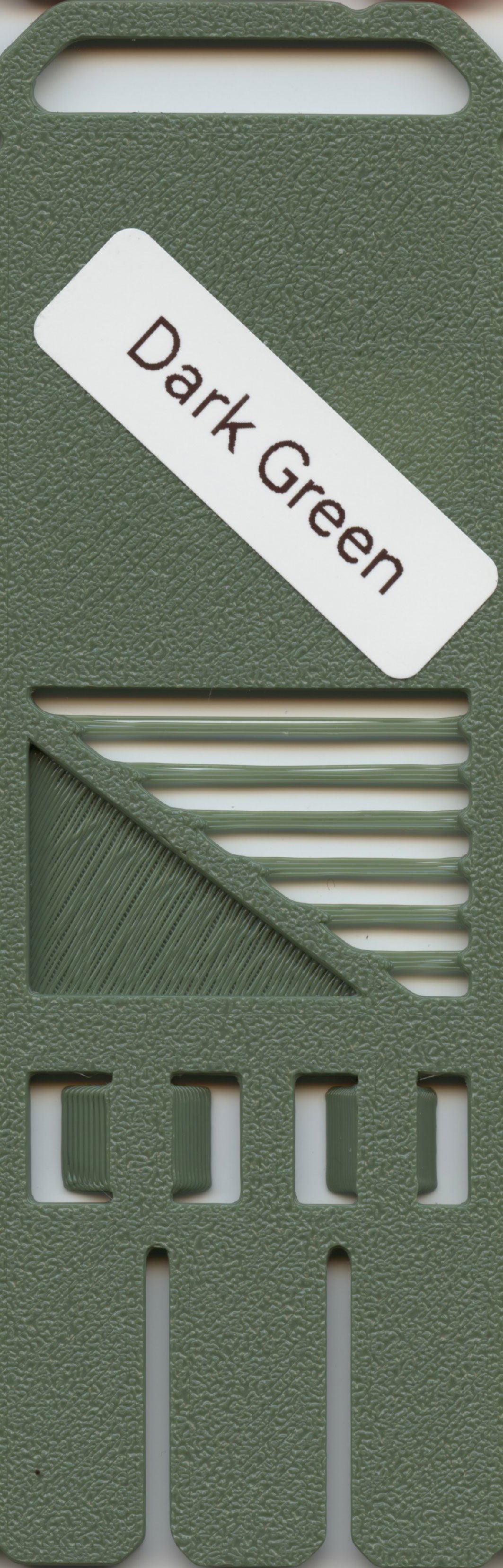 Green plastic appliance with a handle and multiple slots, labeled 'Dark Green'.