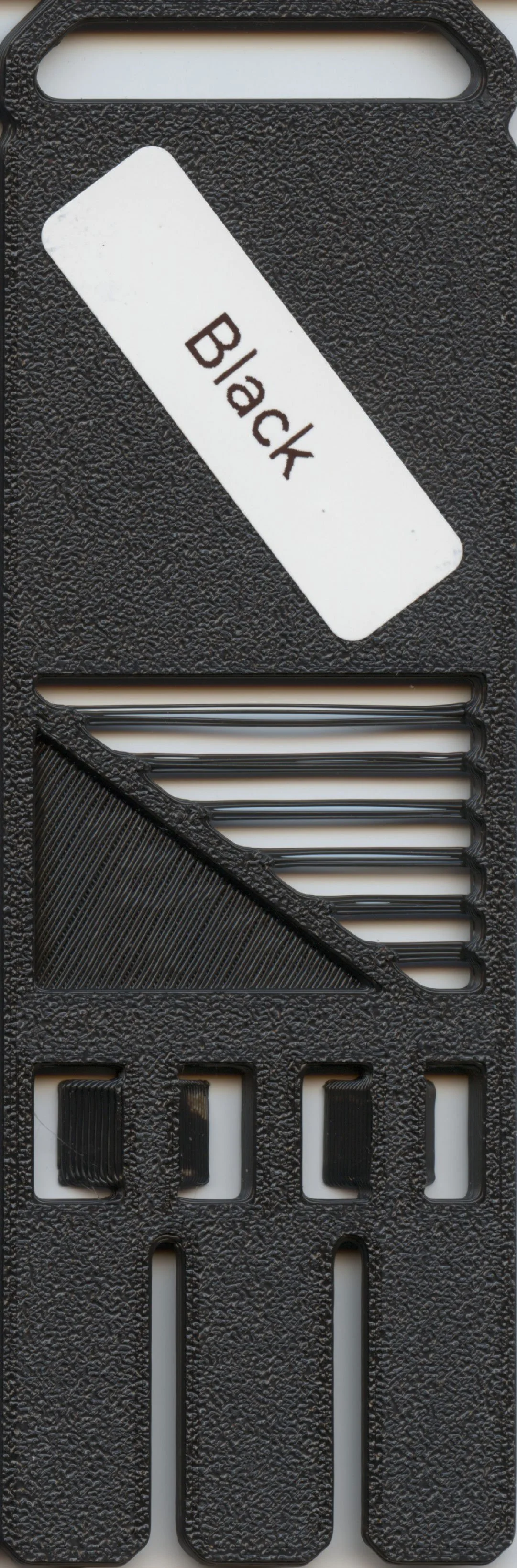Black plastic tray with slots and a white label that reads "Back".