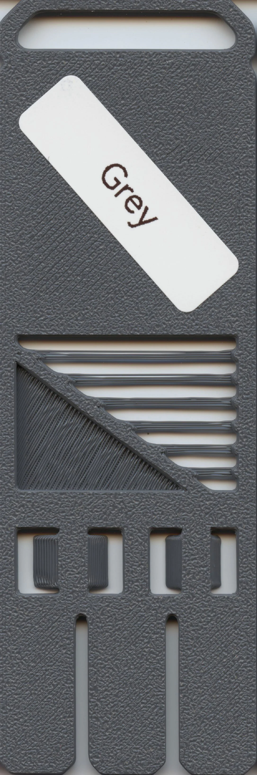 Gray plastic file organizer with a white label that says 'Grey' and multiple slots for organizing papers.