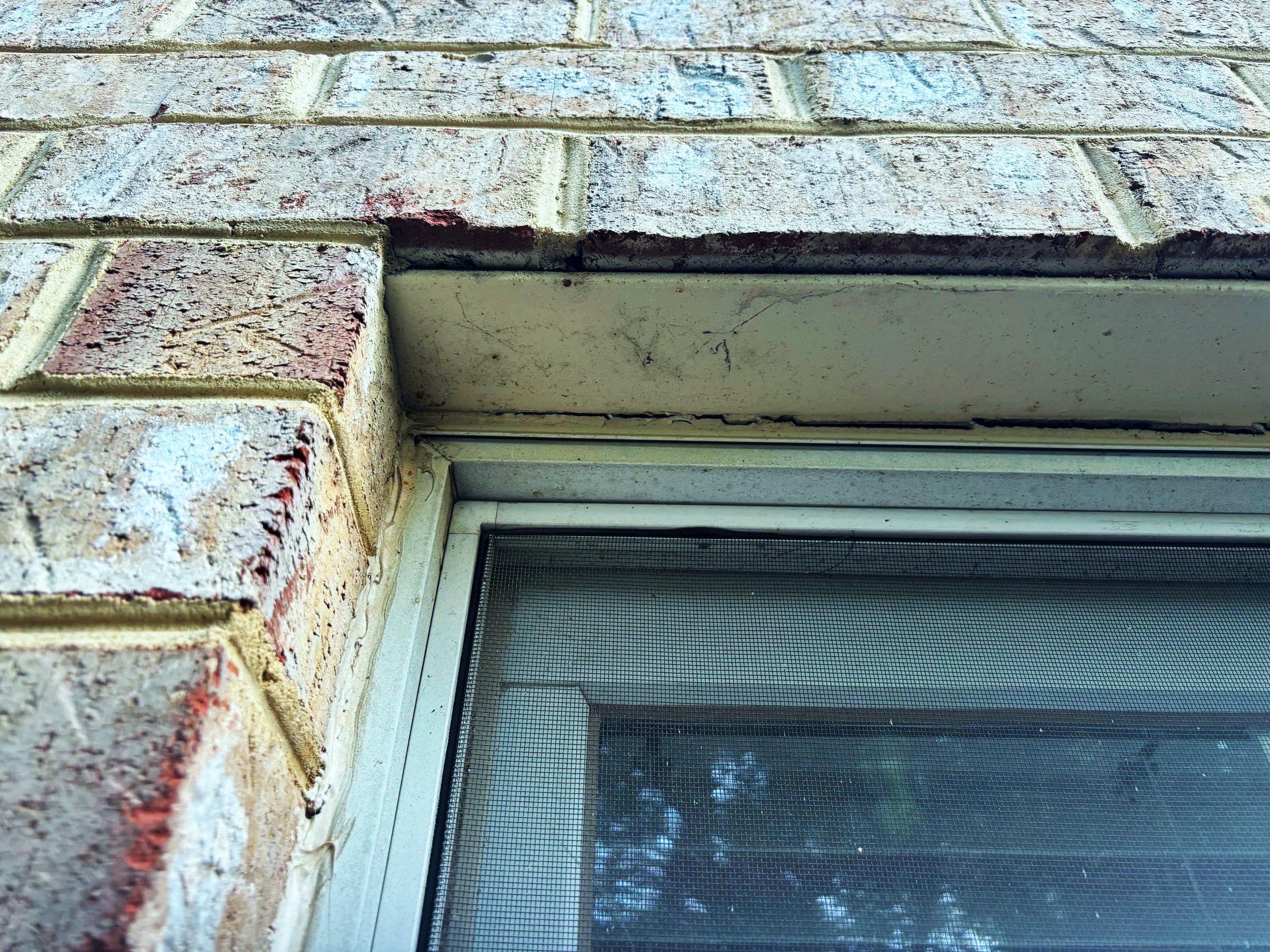 Window with cracked caulking.
