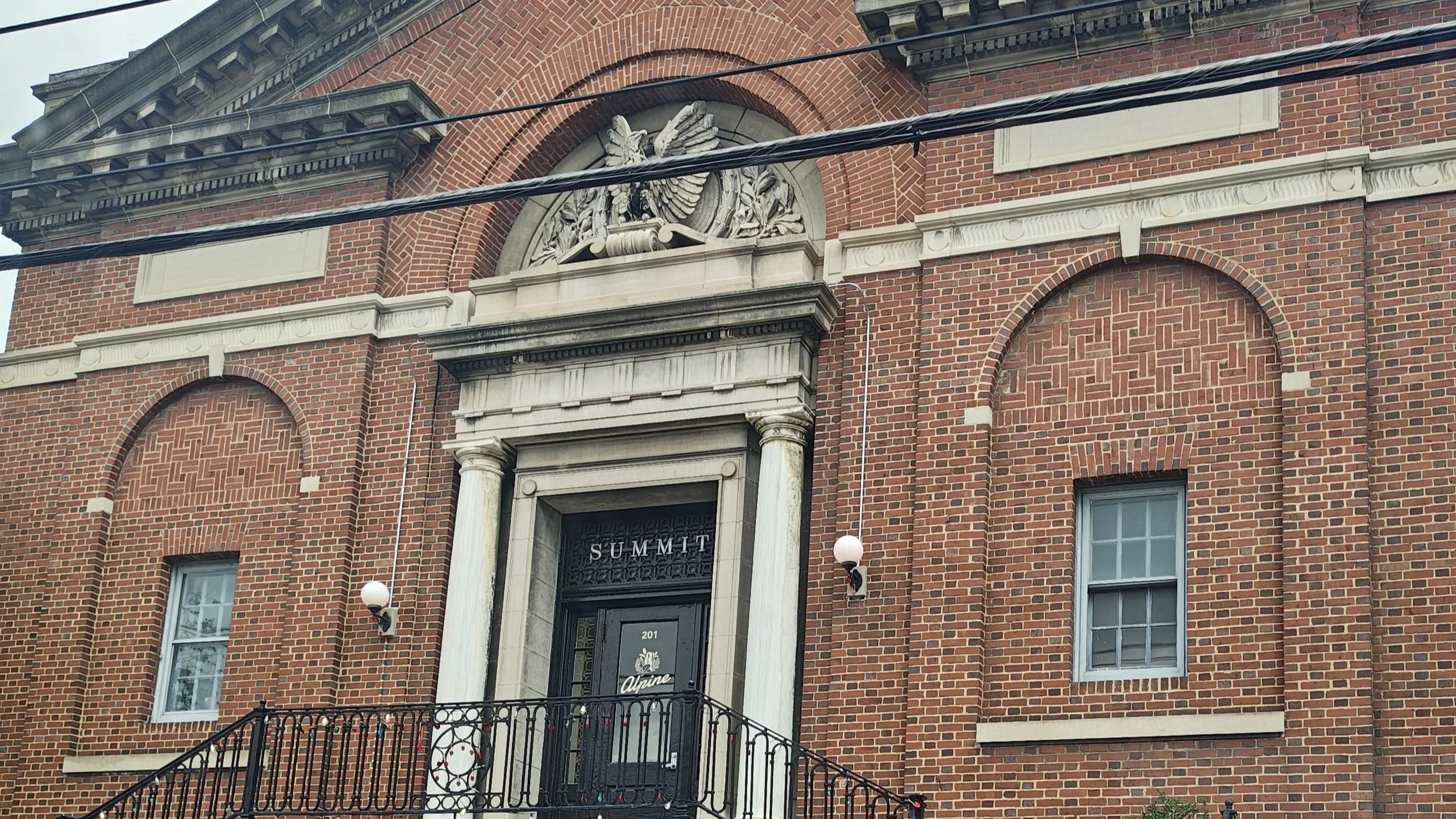 A detailed architectural shot of a brick building featuring intricate designs and classic structural elements.