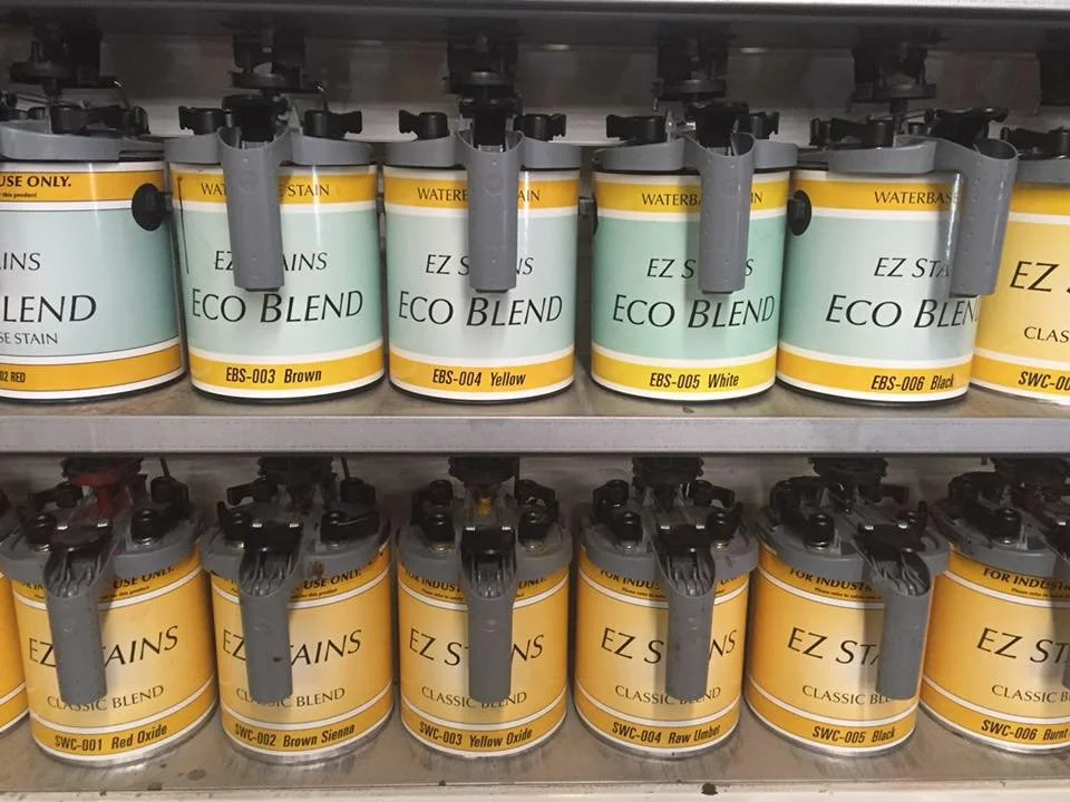 Multiple shelves holding cans of EZ Stains, with various colors and labels, organized by color and type