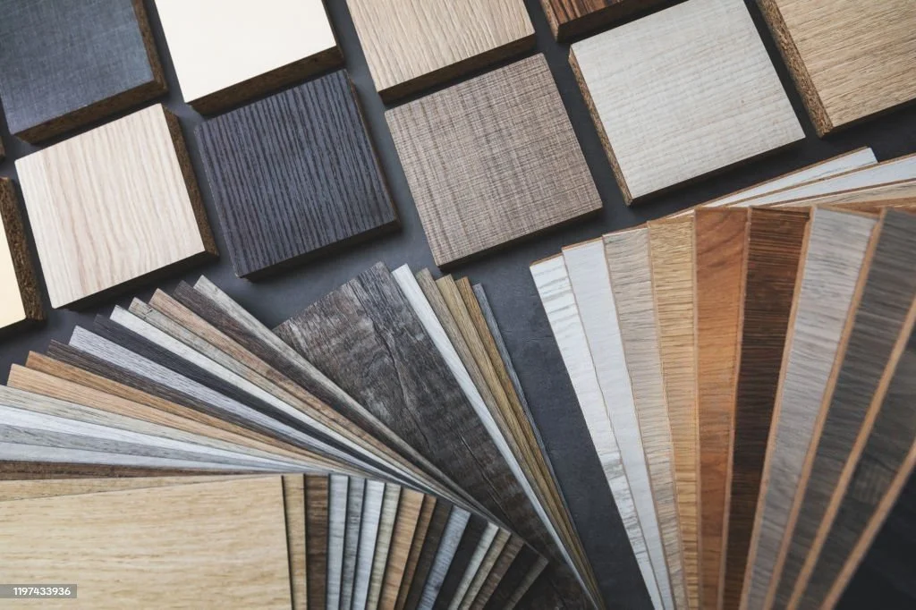 Display case filled with various wood stain samples arranged by color in a retail or hardware store.