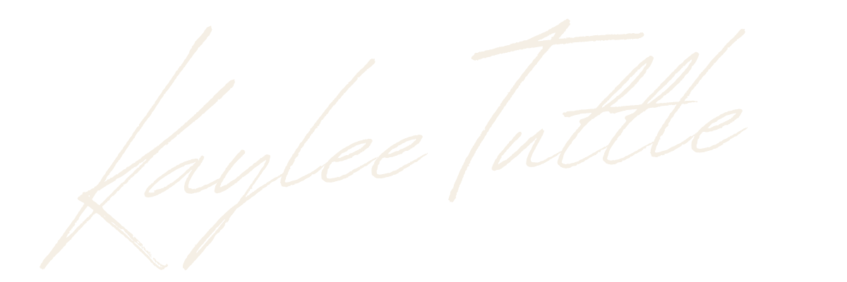 Stylized white handwritten text says 'Laylee Tuttle' on a black background.