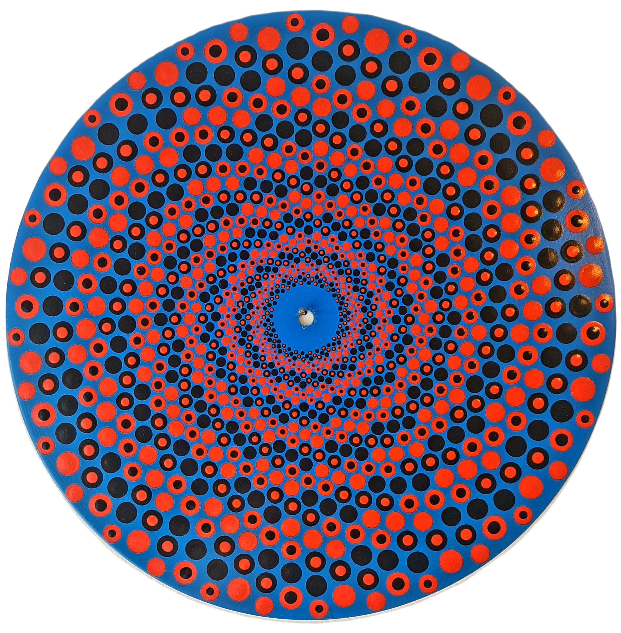 Close-up of a circular, blue optical disc with a pattern of tiny red and black circles creating a spiral design.