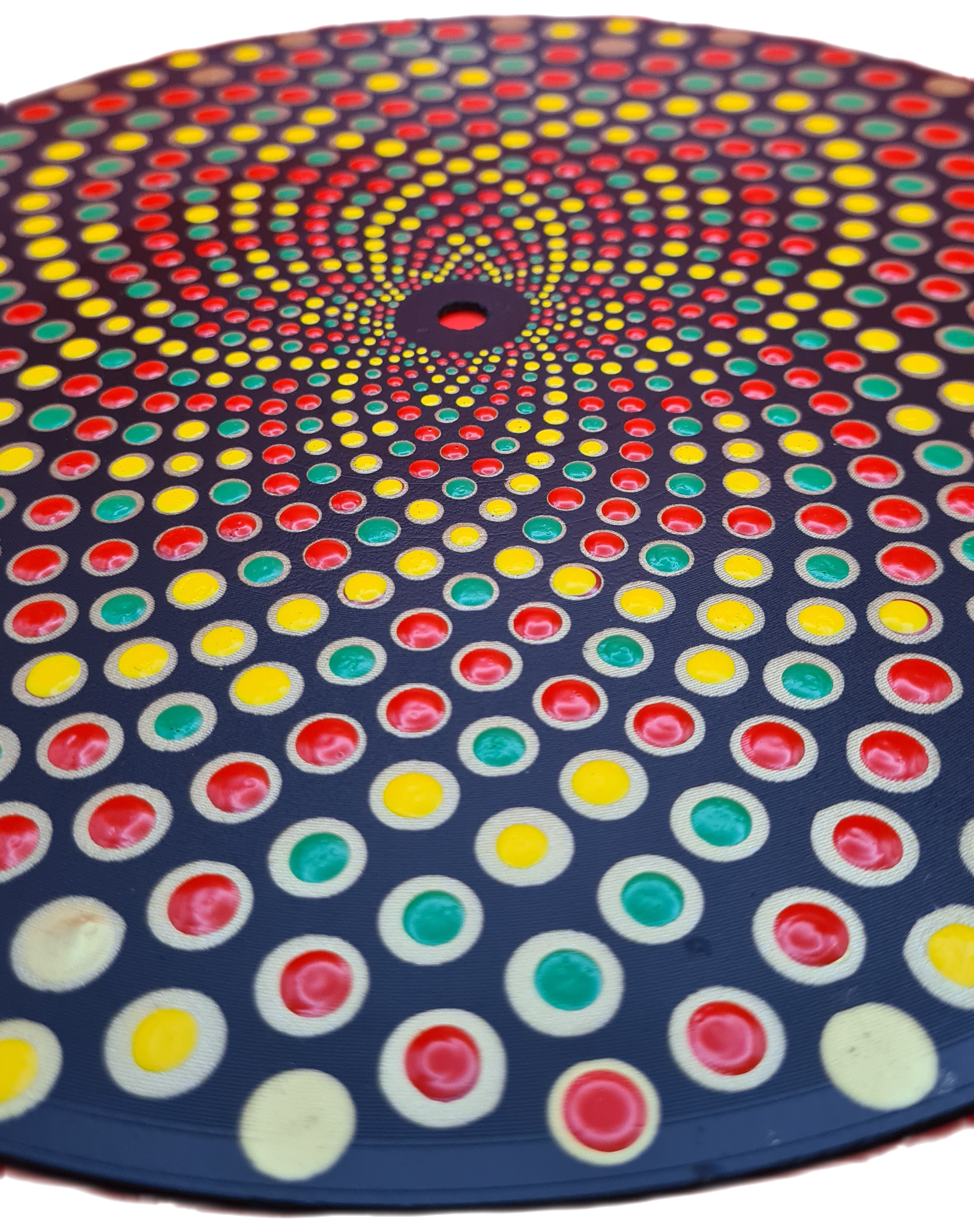 Circular perforated surface with multicolored dots in red, yellow, and green, arranged in a spiral pattern.