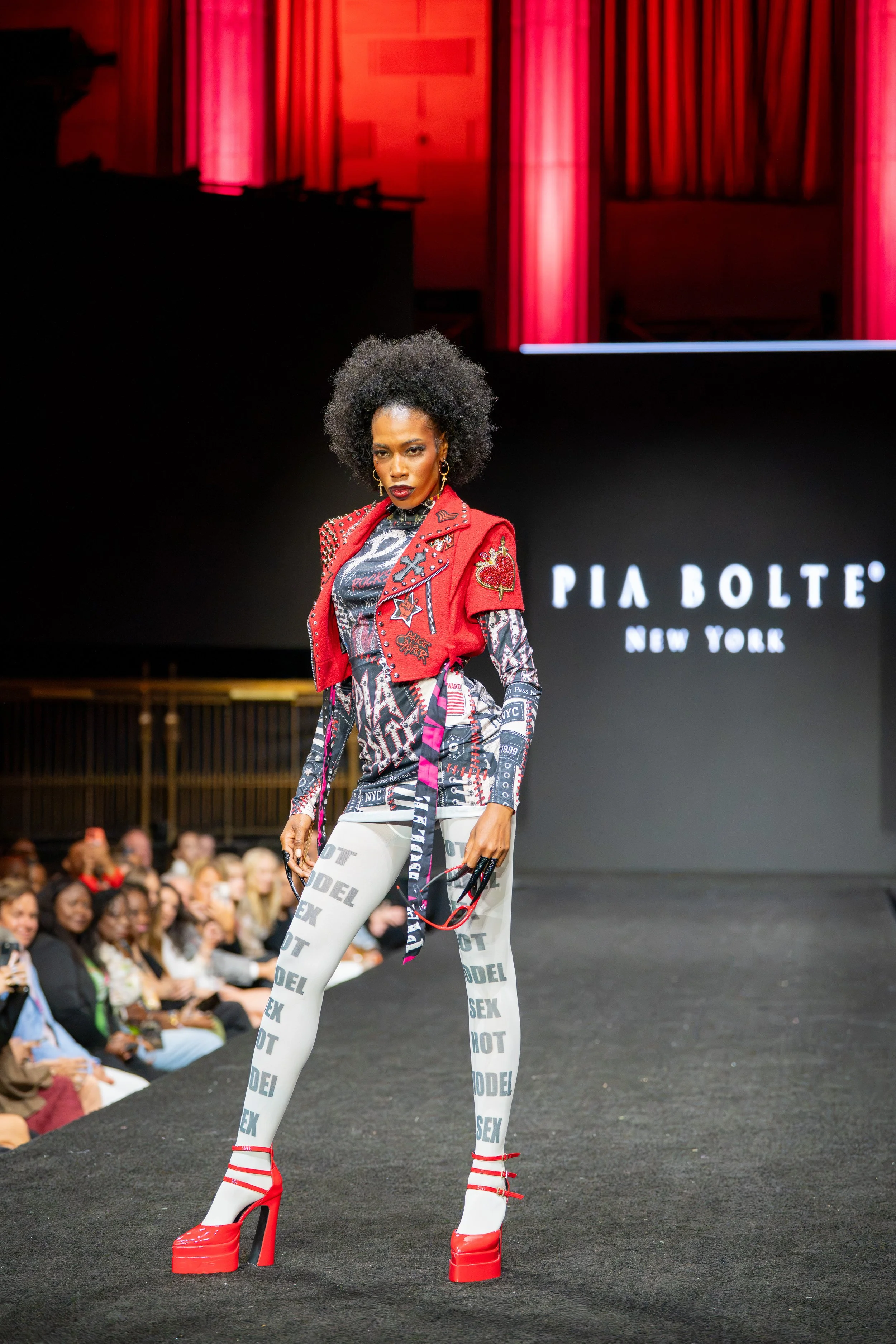 Model wearing a red Pia Bolte vest, printed leggings and red platform shoes during the Pia Bolte New York Fashion Week runway show.