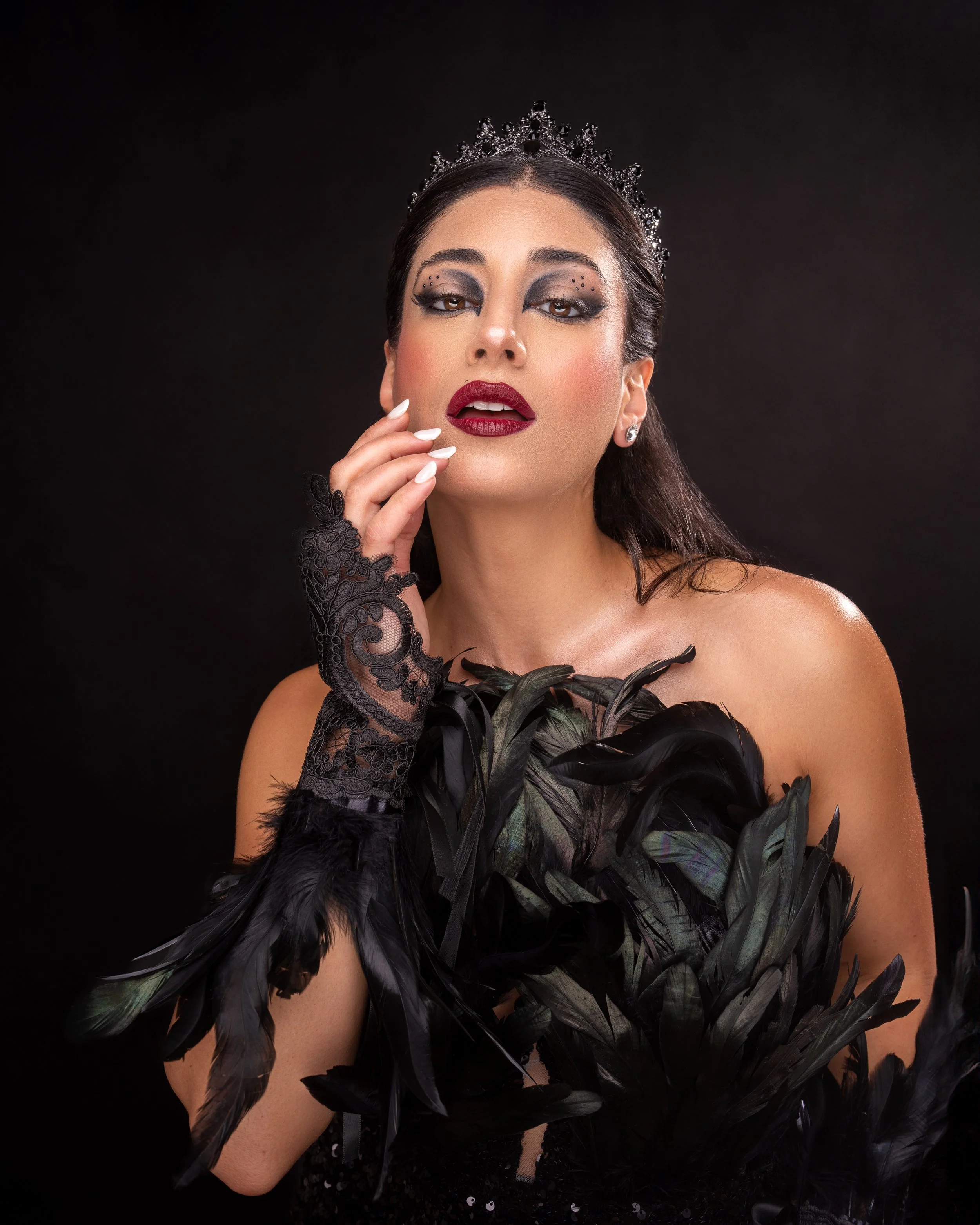 Beauty editorial portrait featuring dramatic makeup and elegant studio lighting.