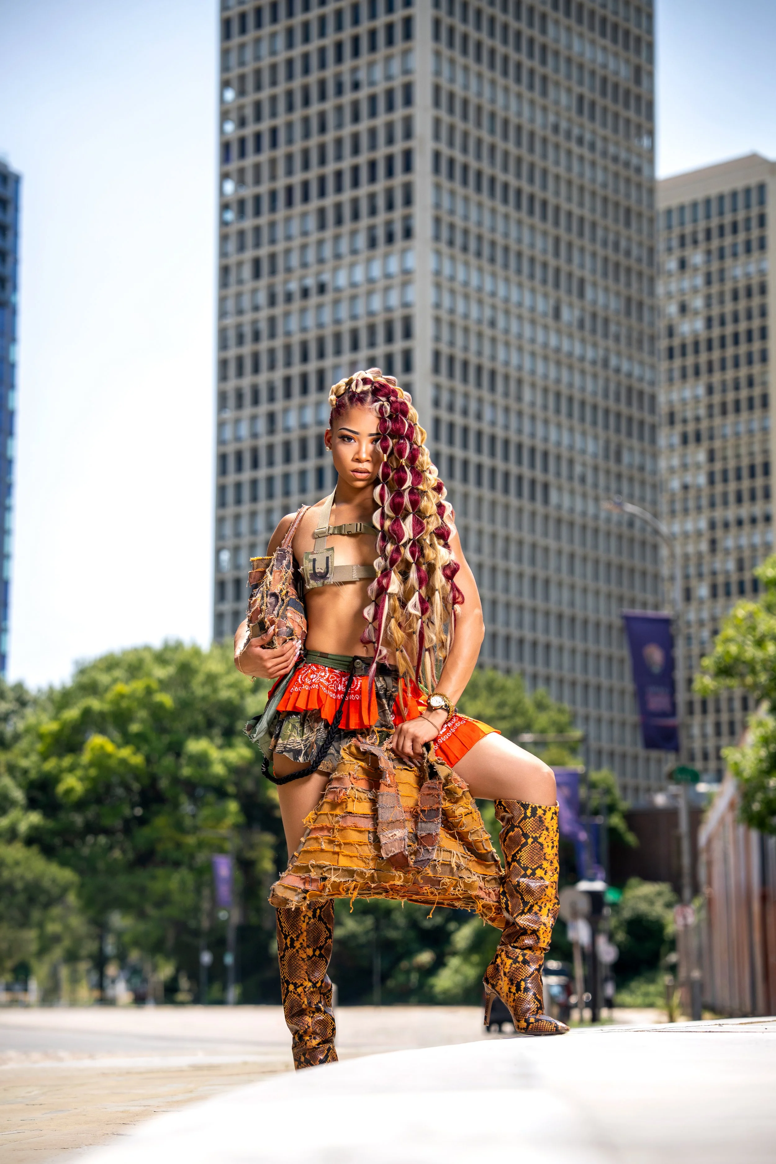 Bold editorial portrait blending avant-garde fashion with Philadelphia's urban architecture, creating a striking balance between high fashion styling and modern city landscapes.