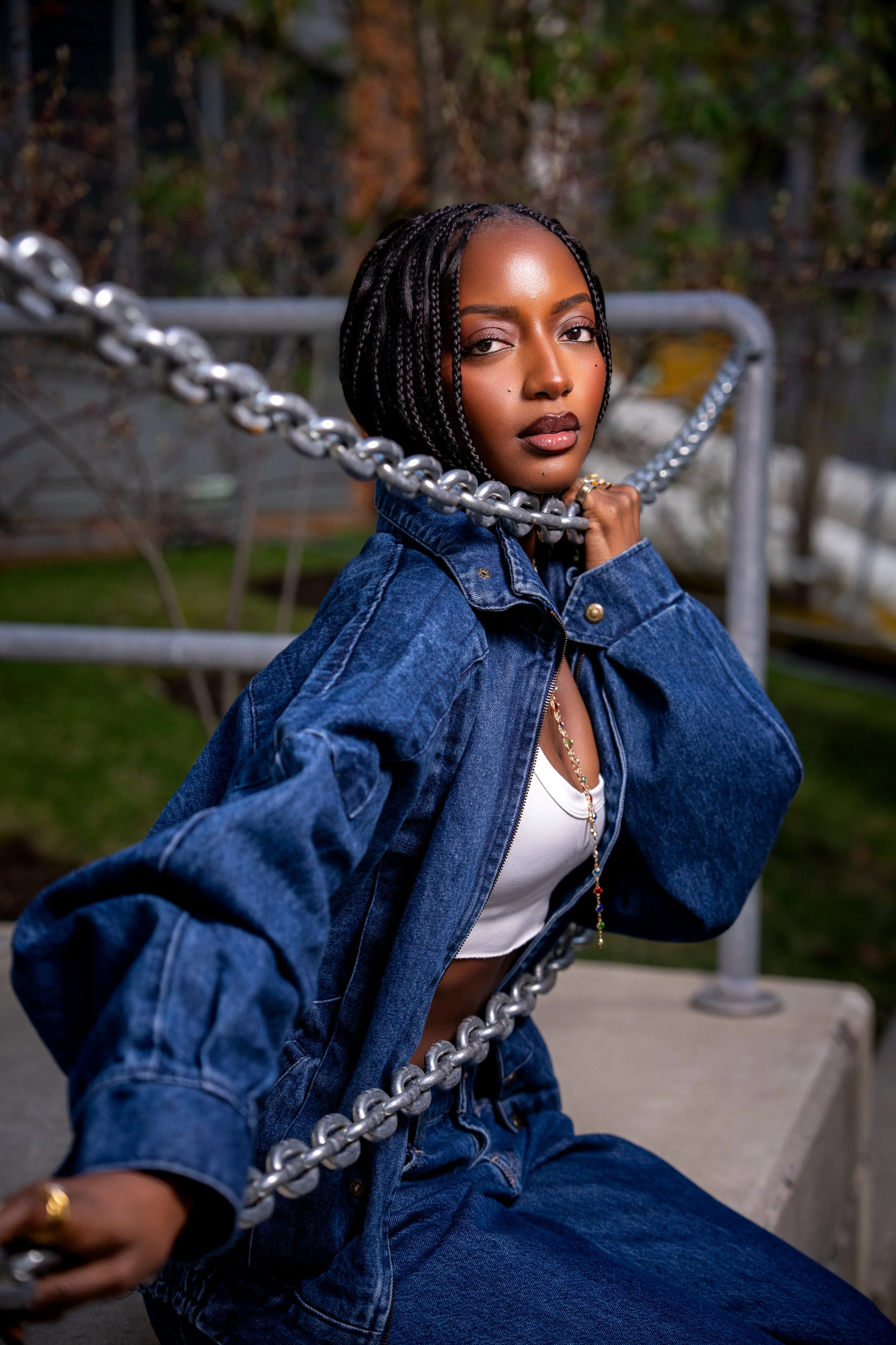 Creative editorial portrait featuring a model in a blue fashion jacket with artistic composition.