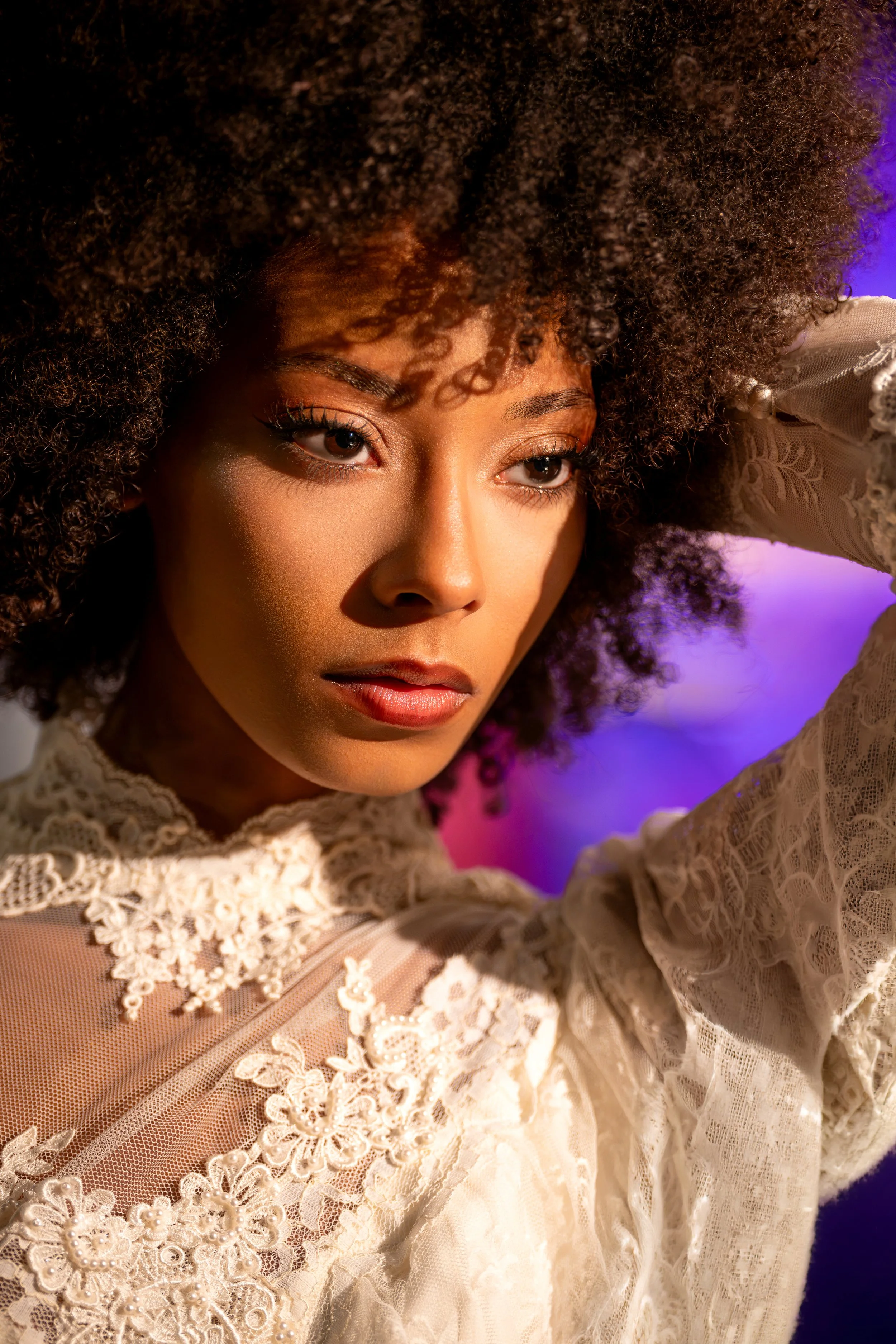 Moody editorial close-up portrait with cinematic lighting and expressive styling.