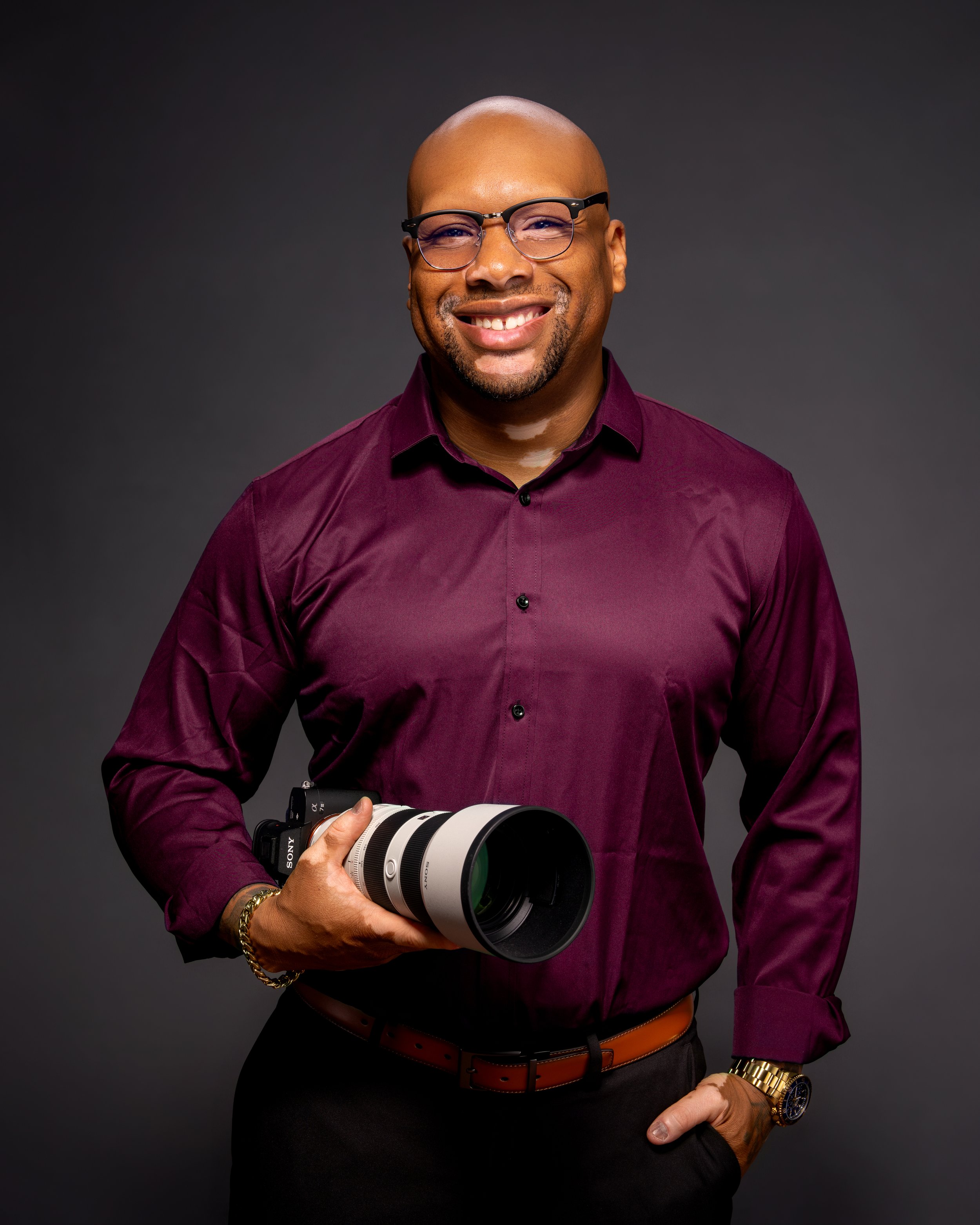 Professional portrait photographer Randall Robinson of Ran With A Cam in Philadelphia holding camera in studio portrait