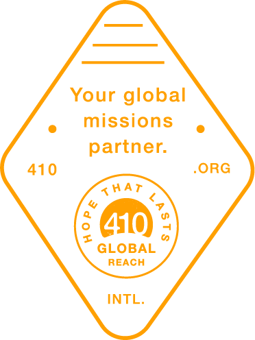 Orange diamond-shaped label for Hope That Lasts 410, a global mission partner, with text and circular logo.
