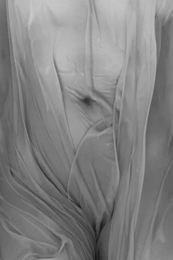 Close-up of a blanket or fabric with wrinkles and folds.