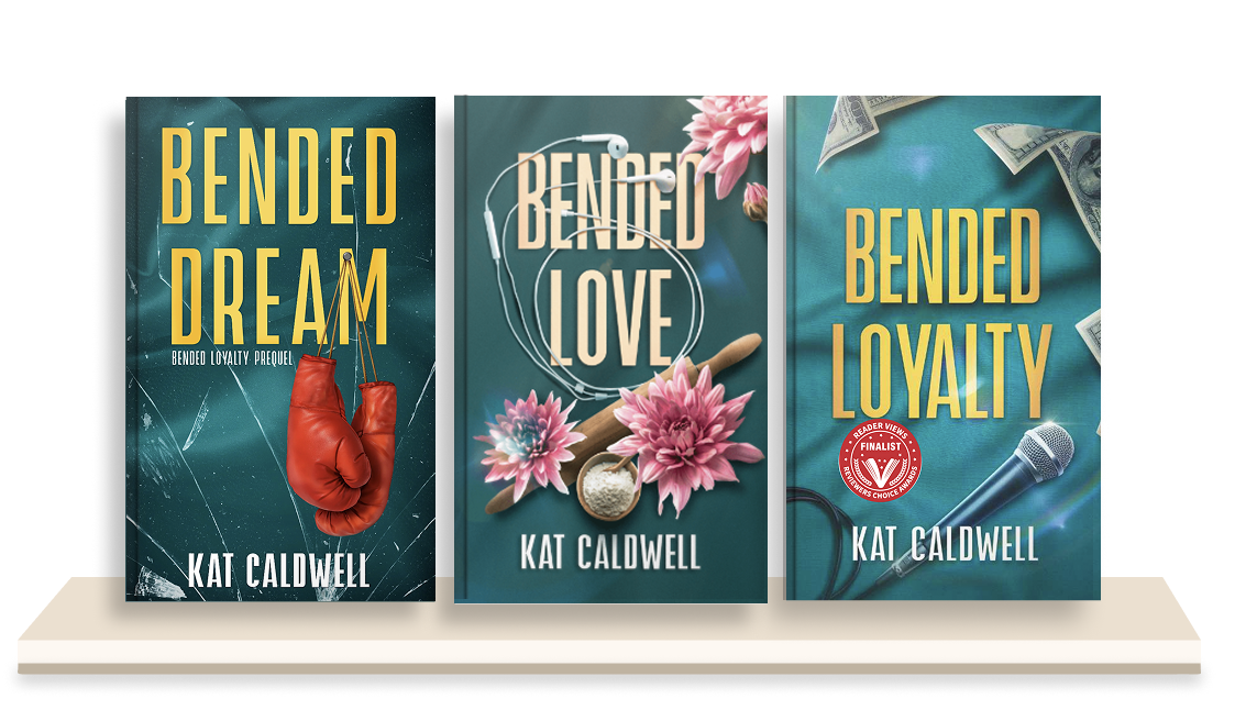 Three books in a series titled "BENDED LOYALTY" by Kat Caldwell displayed on a beige shelf. The first book has a dark teal cover with a boxing glove; the second has a teal cover with pink flowers and a wooden spoon; the third has a teal cover with money and a microphone.