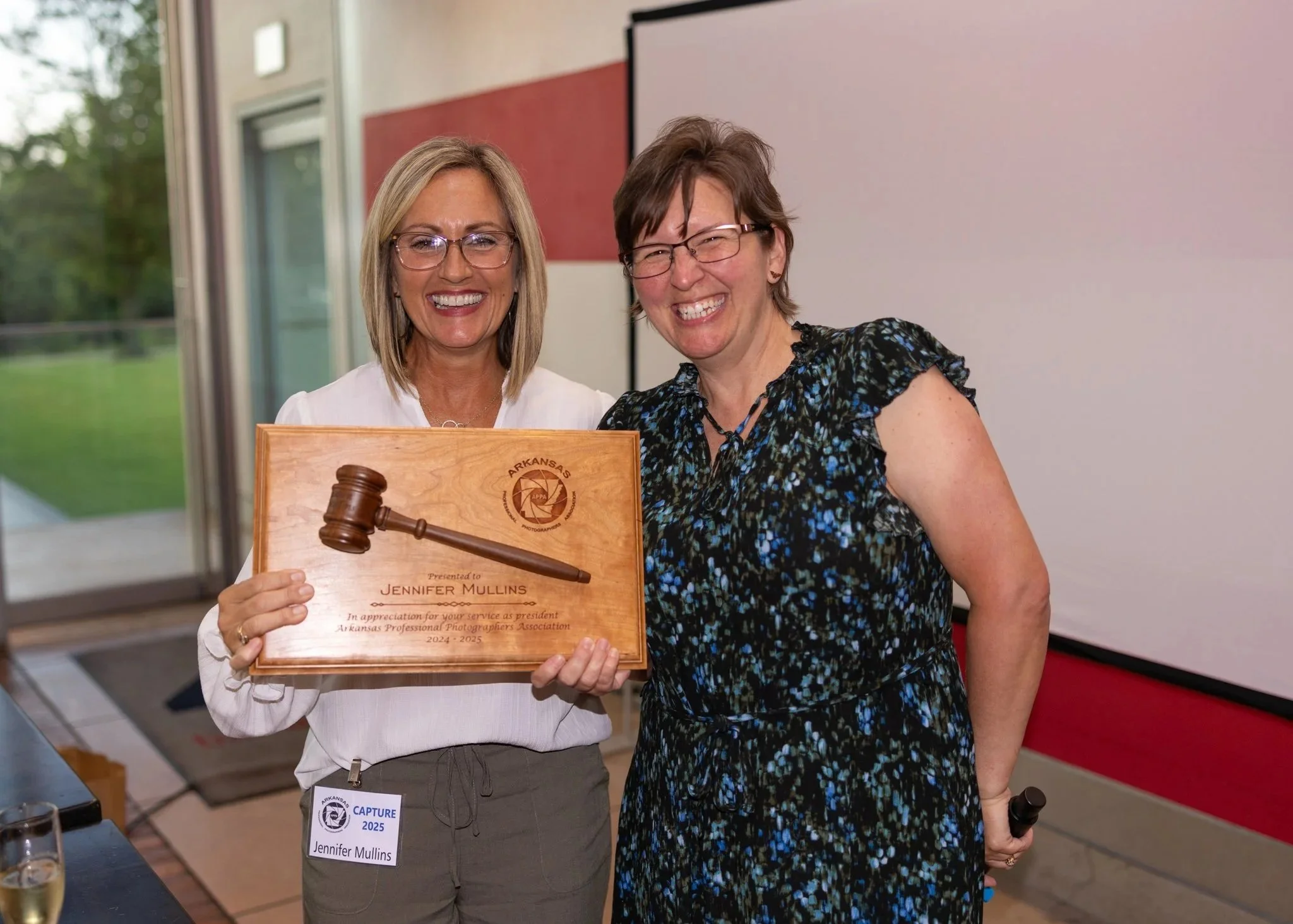 Passing the Gavel. Outgoing President, Jennifer Mullins hands the gavel to incoming President Shauna Raduske