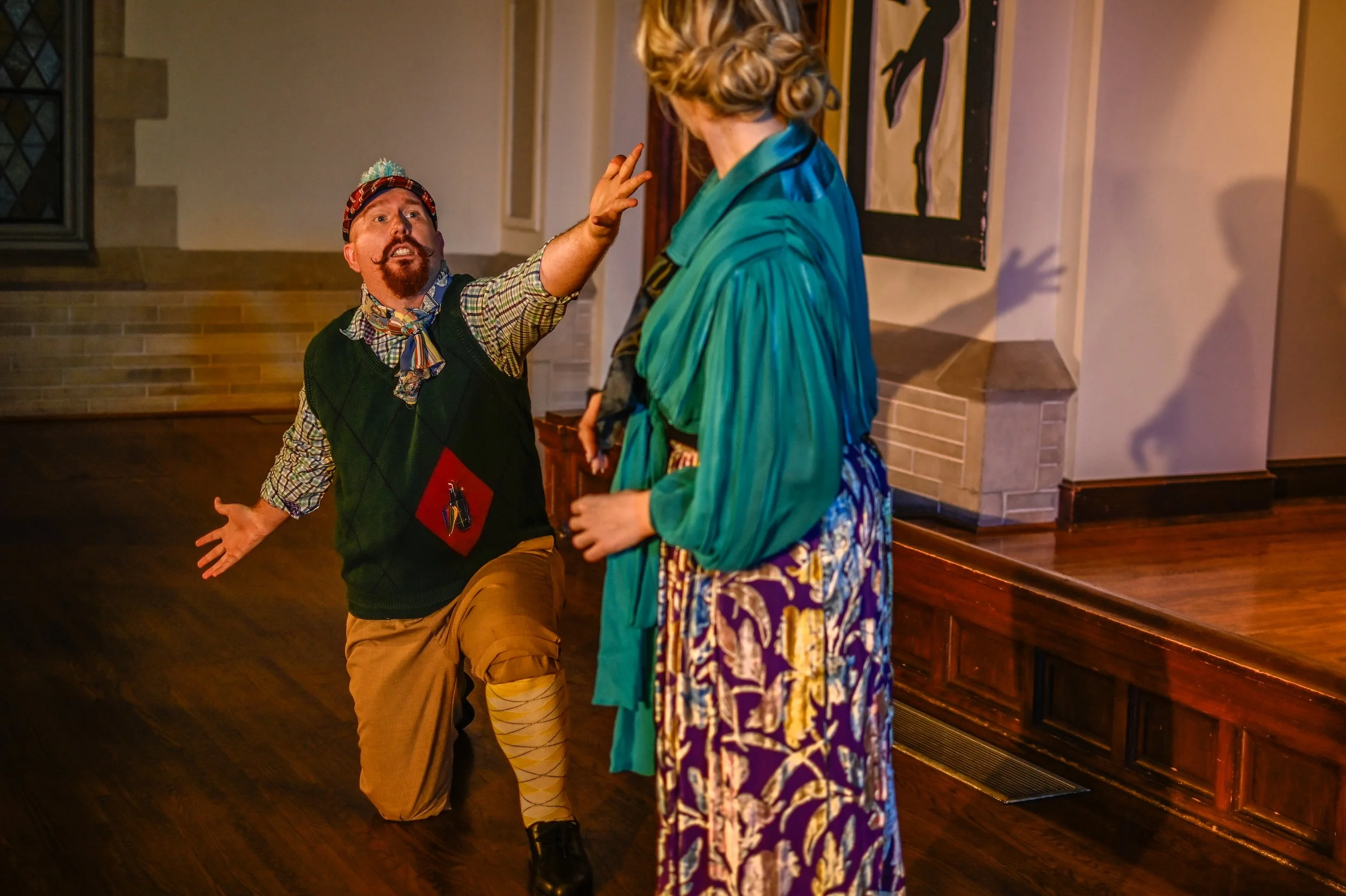 Photograph of Malvolio (Andrew Smith) pleading to Olivia (Lydia Gray)