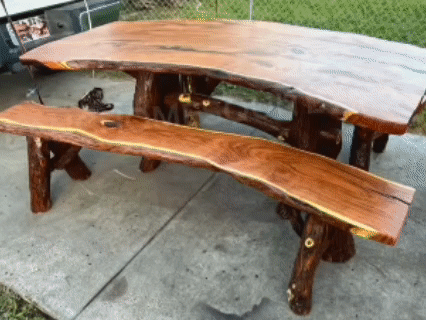 Wooden outdoor dining table and bench on a concrete patio