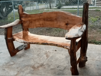 Handcrafted wooden bench with a rustic design, featuring natural wood finish and a simple structure.