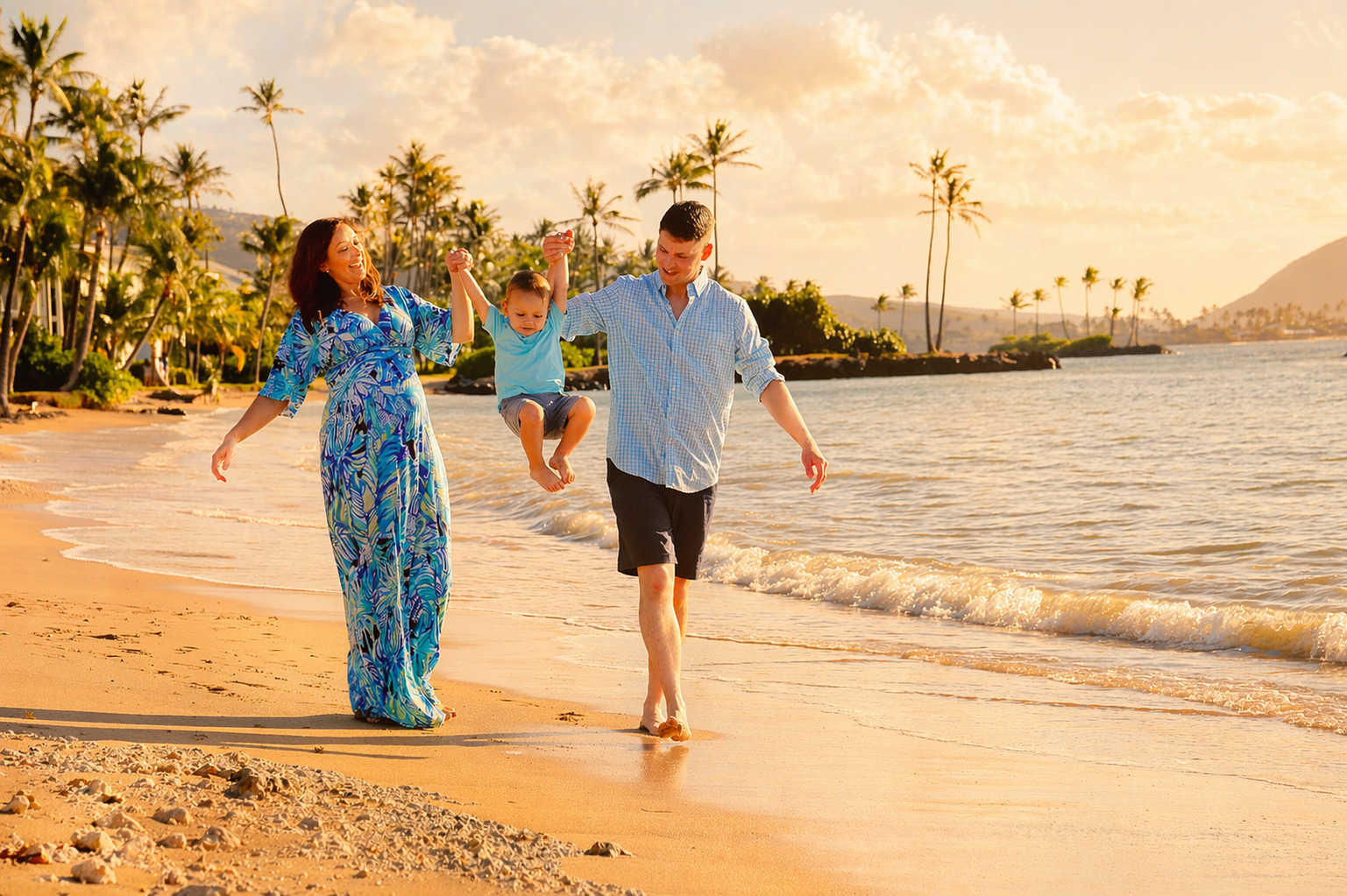 Family of three having fun on the beach during sunset, with palm trees in the background.
