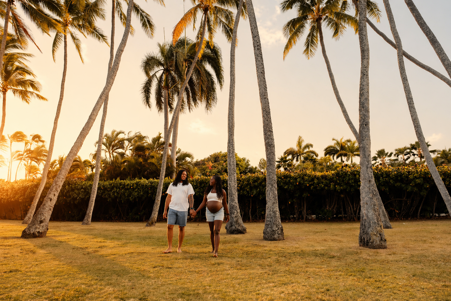 A couple walking hand in hand in a tropical park during sunset, with tall palm trees and lush greenery around.