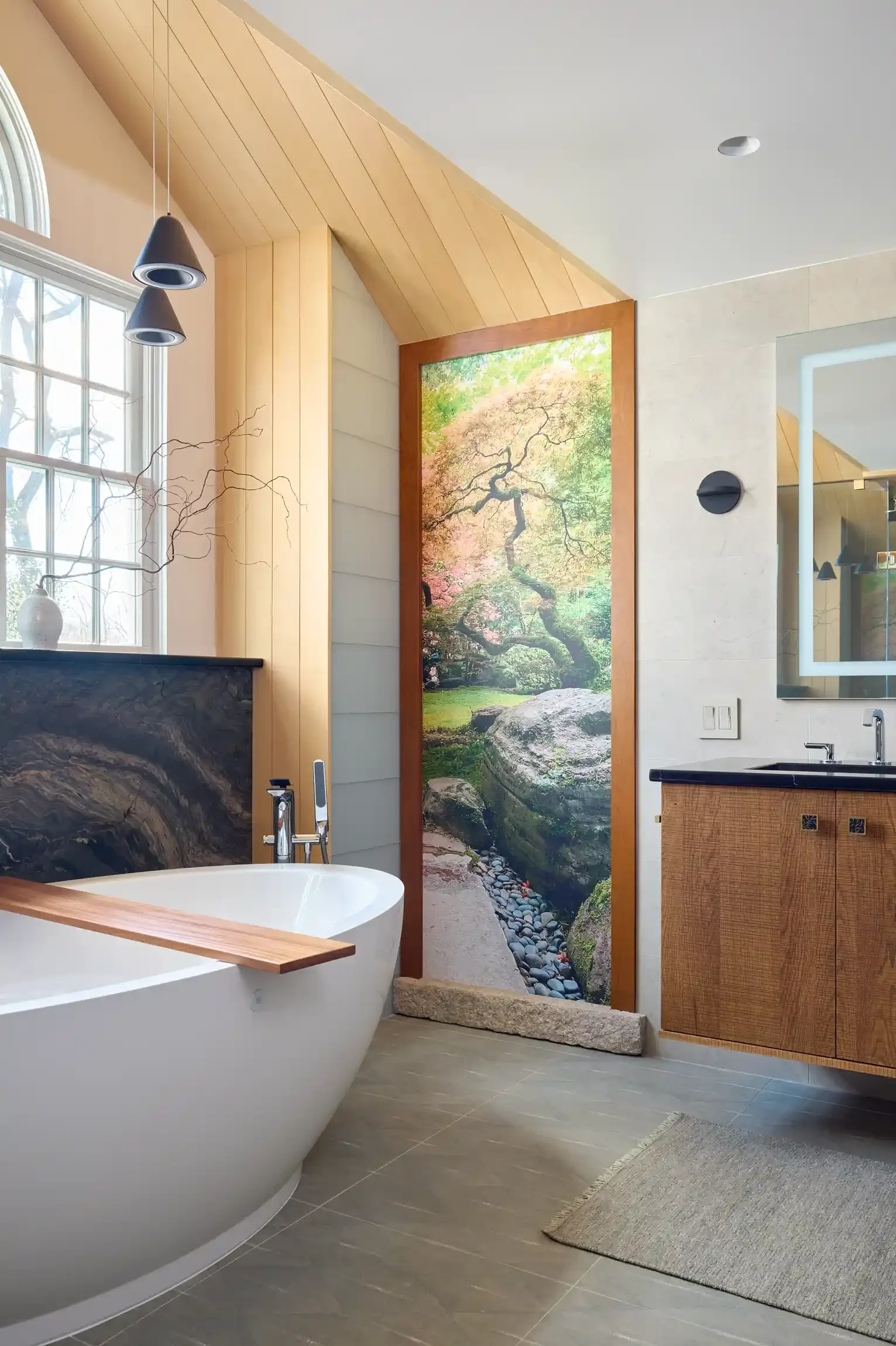 Bathroom with modern design, featuring a freestanding bathtub, wood-paneled walls, a large window and a black countertop with a wooden cabinet. By New Jersey photographer Bartholomew Studio.
