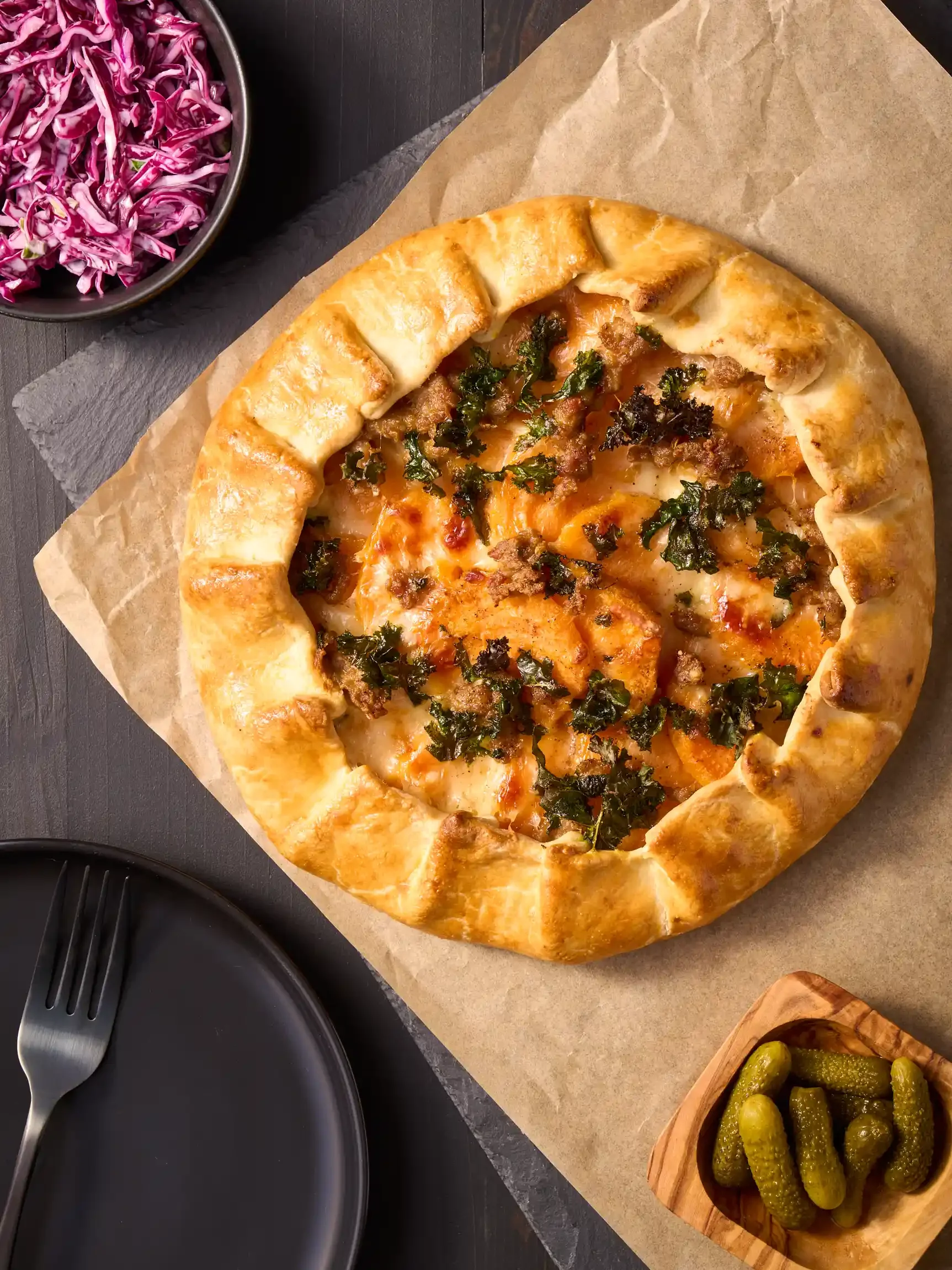 A cheese tart with a thick, golden crust topped with melted raclette cheese. By Philadelphia, PA & NJ food photographer & food stylist team Bartholomew Studio.