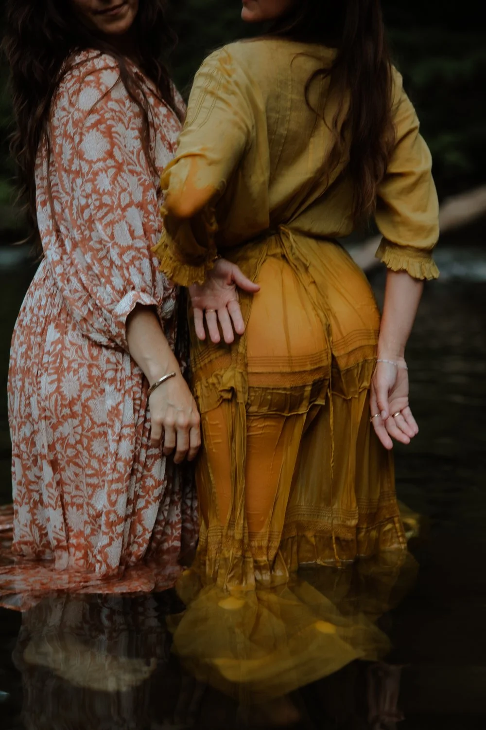 Editorial branding portrait of female health coaches in the river fully dressed