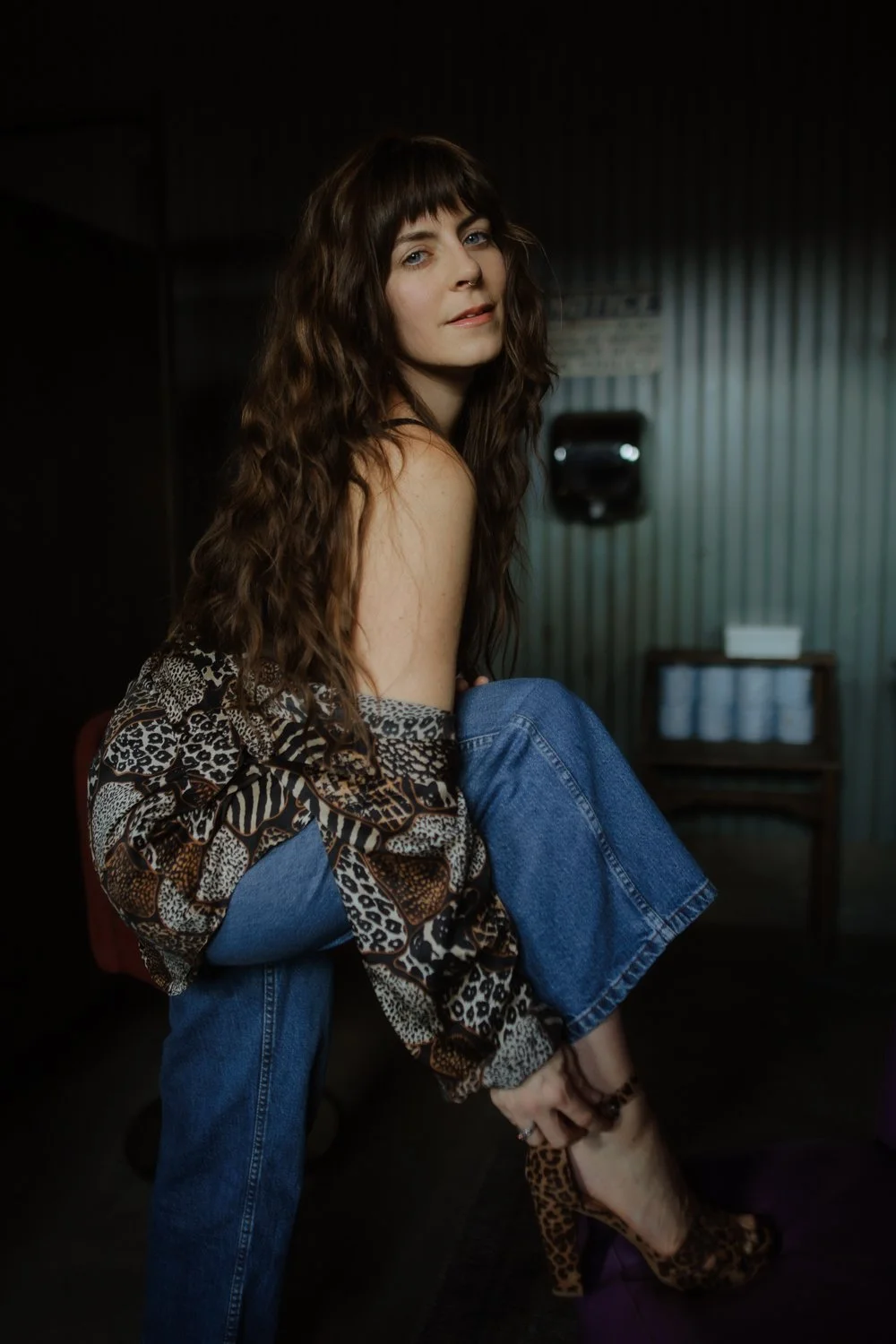 Editorial branding portrait of female entrepreneur pushing the boundaries in a women's bathroom