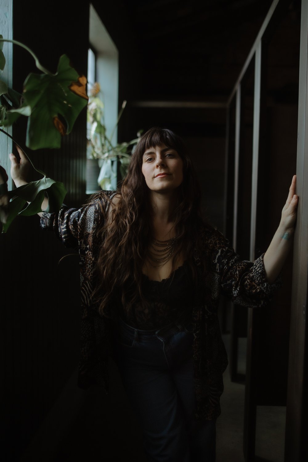 Editorial branding portrait of female entrepreneur in contrasted light adding mood and drama