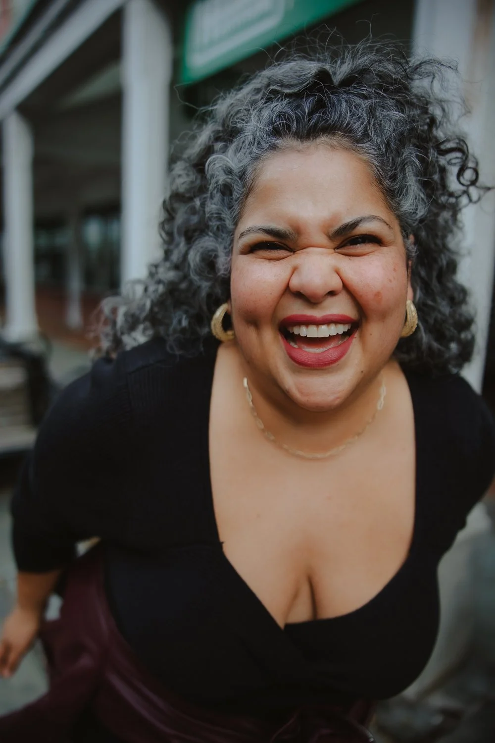 Editorial branding portrait of female entrepreneur smiling with huge joy