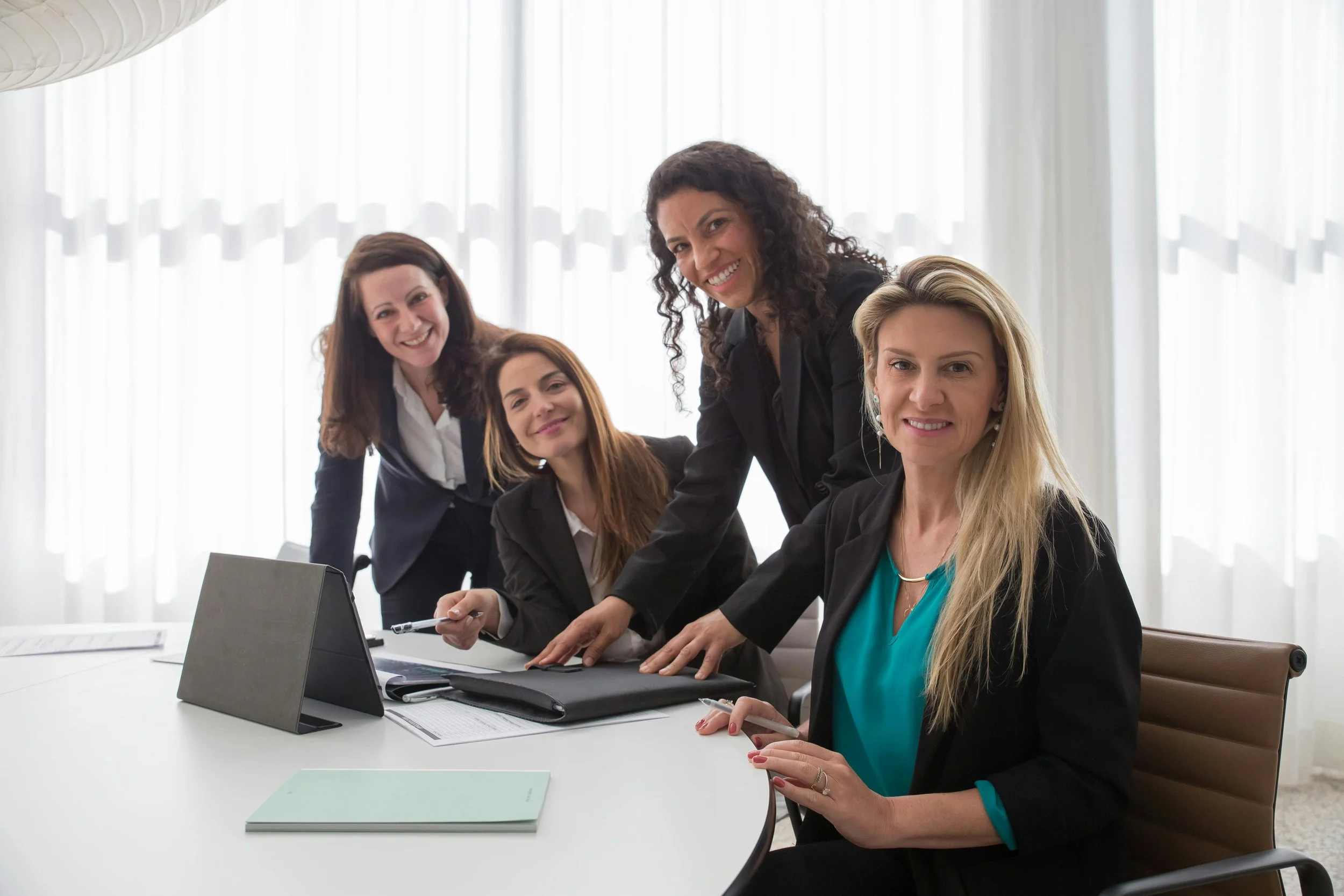 Female professionals working at a tablet.